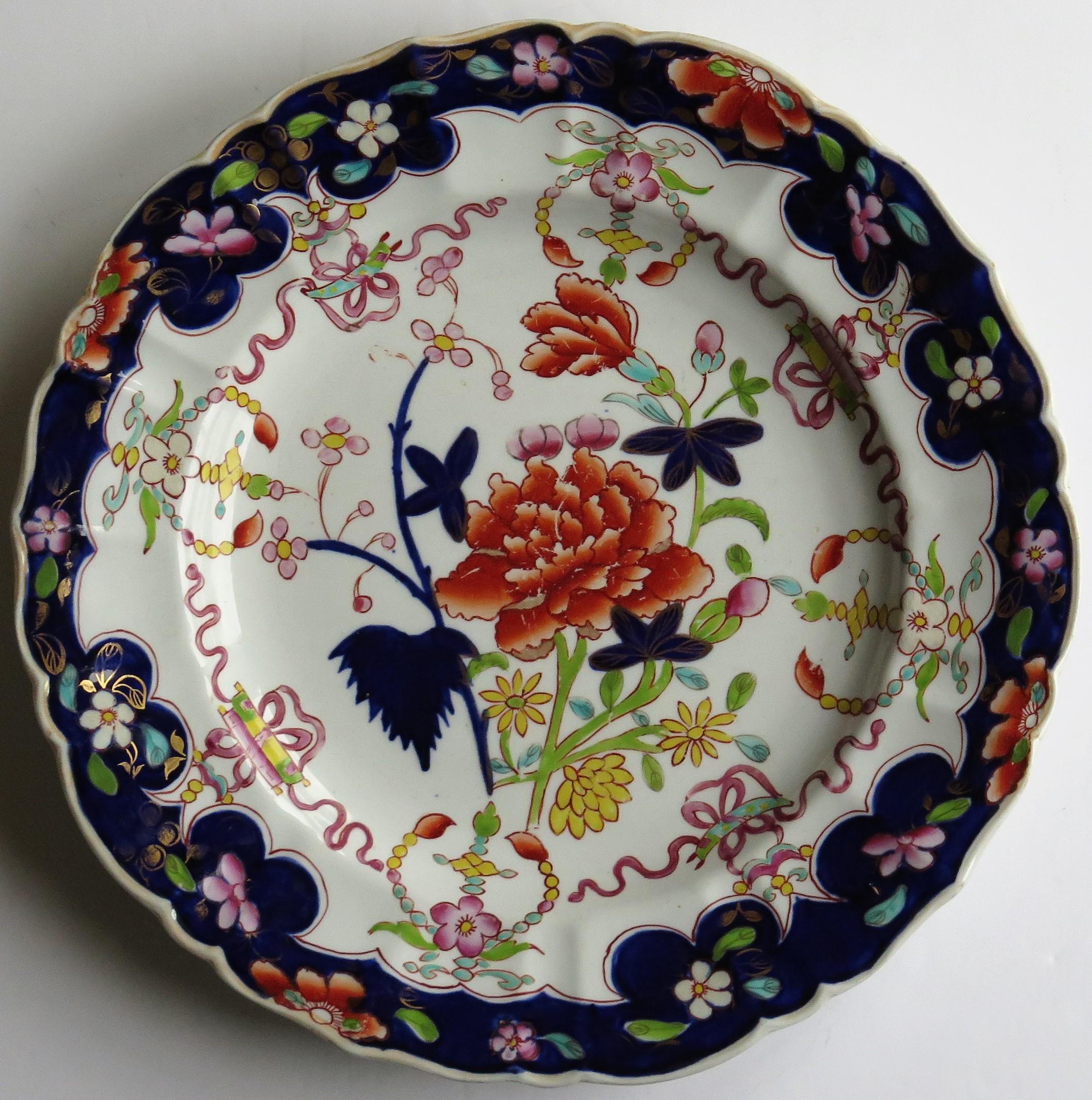 This distinctive ironstone pottery large dinner plate was made by the Mason's factory at Lane Delph, Staffordshire, England and is hand decorated in the 