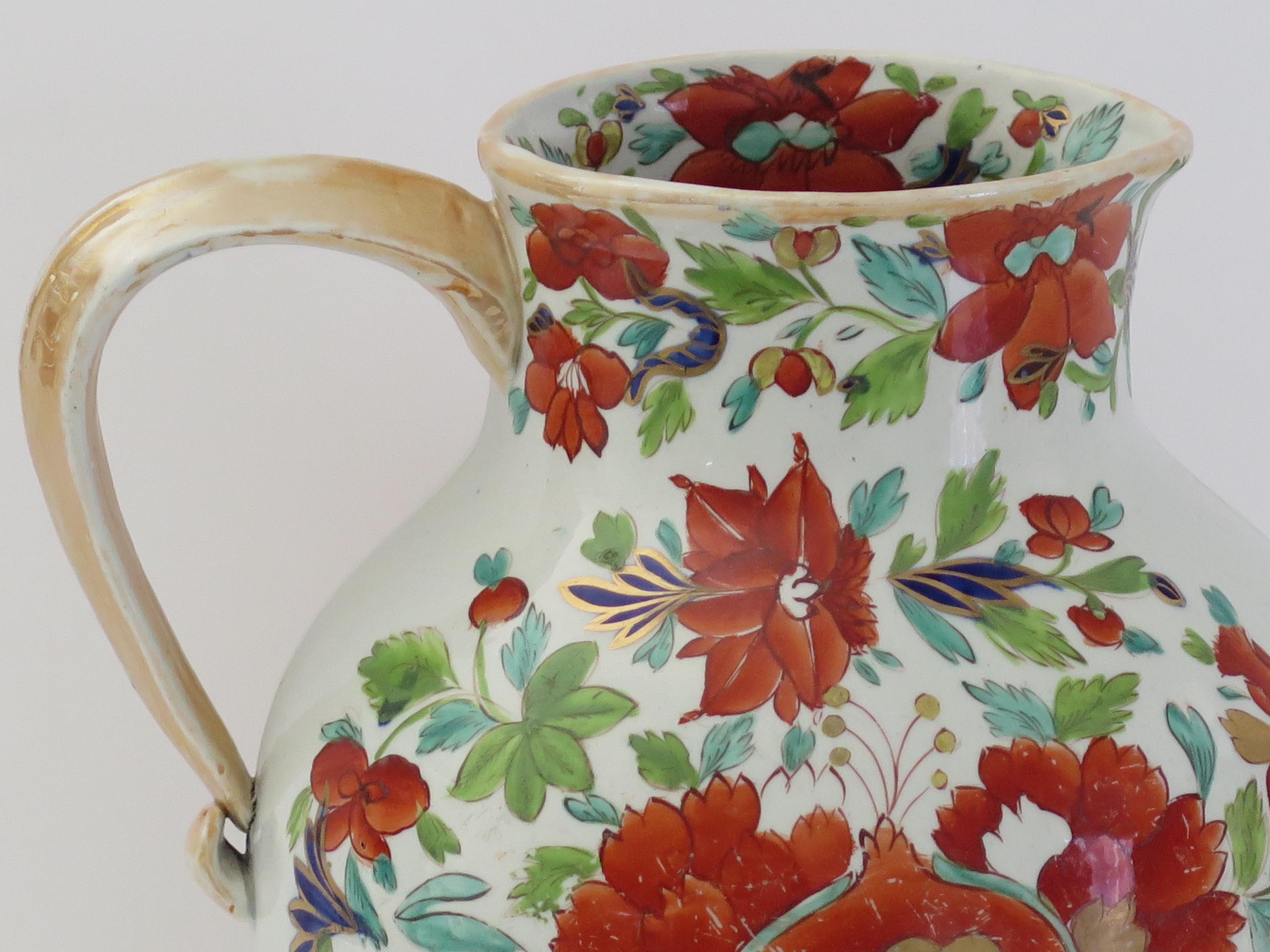 This is a rare very early large jug or pitcher in one of the rarer shapes, hand painted in the large stamen flower pattern, made by Mason's Ironstone, Lane Delph, England and dating to circa 1813-1820.

The large Jug or pitcher is well potted with