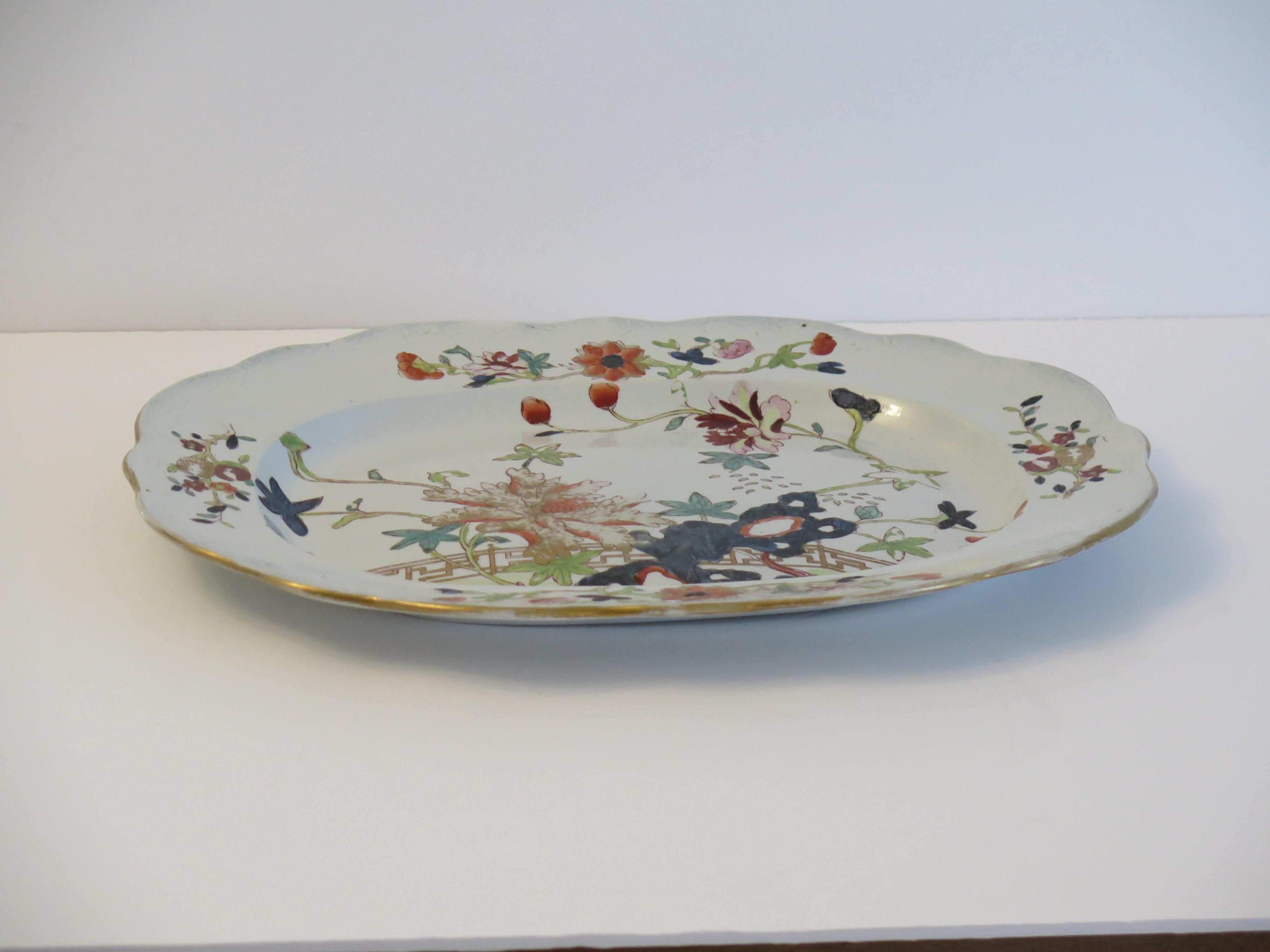 This is a very good hand painted Mason's ironstone large Platter or Meat Plate, in the Fence, Rock and Tree gilded pattern, from their earliest George IIIrd period, circa 1818.

The piece is well potted with an oval shape having a wavy edge with no