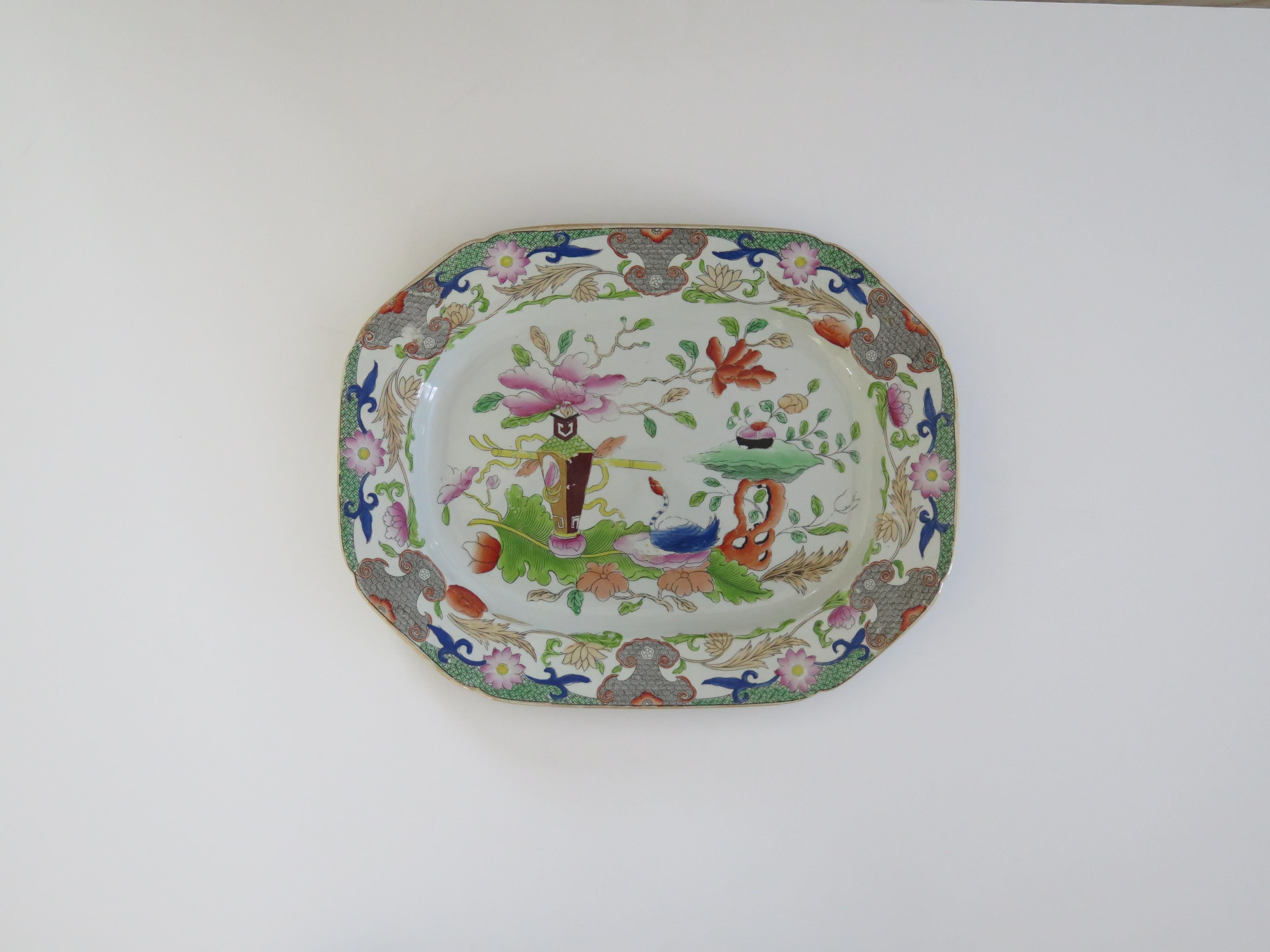 This is a very good hand painted Mason's ironstone large Platter or Meat Plate, in the Table and Flowerpot gilded pattern, from their earliest George IIIrd period, circa 1818.

The piece is well potted with an oval octagonal shape having indented