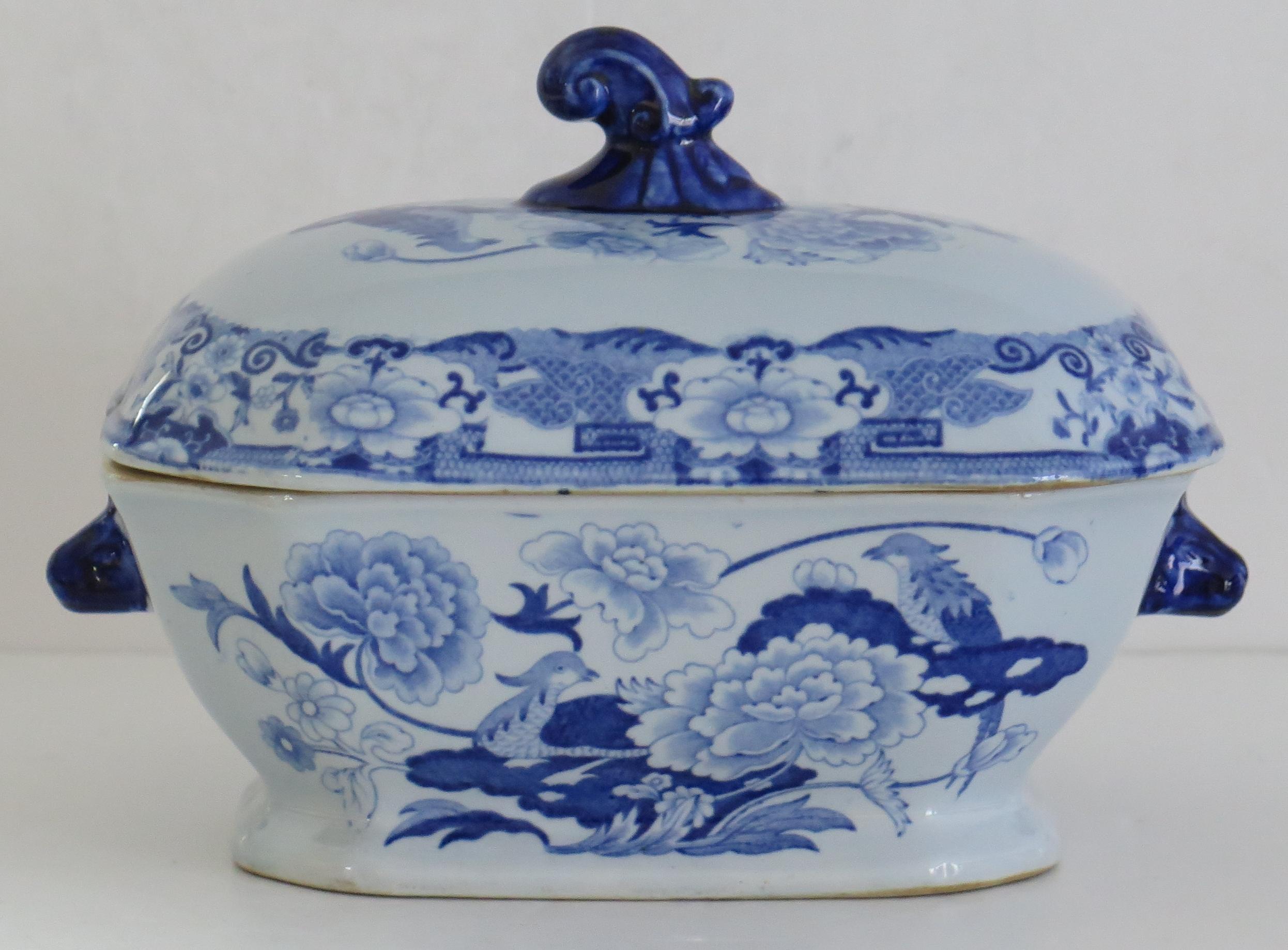 This is a good Ironstone Sauce Tureen, complete with lid, made by Mason's of Lane Delph, Staffordshire, England, during the early part of the 19th century, circa 1815.

This tureen is well potted with a rectangular curved shape on a low foot.
