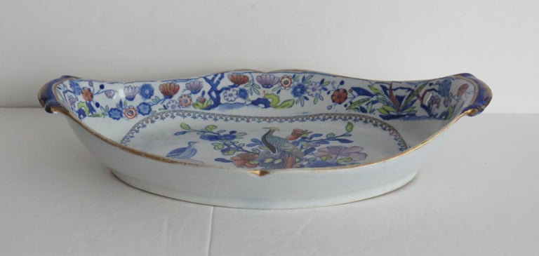 This is a very decorative serving dish or tray by Mason's Ironstone, Lane Delph, England in the Oriental Pheasant pattern, dating to the very early period of Mason's ironstone, circa 1820.

The dish is oval in shape with upturned sides, a notched