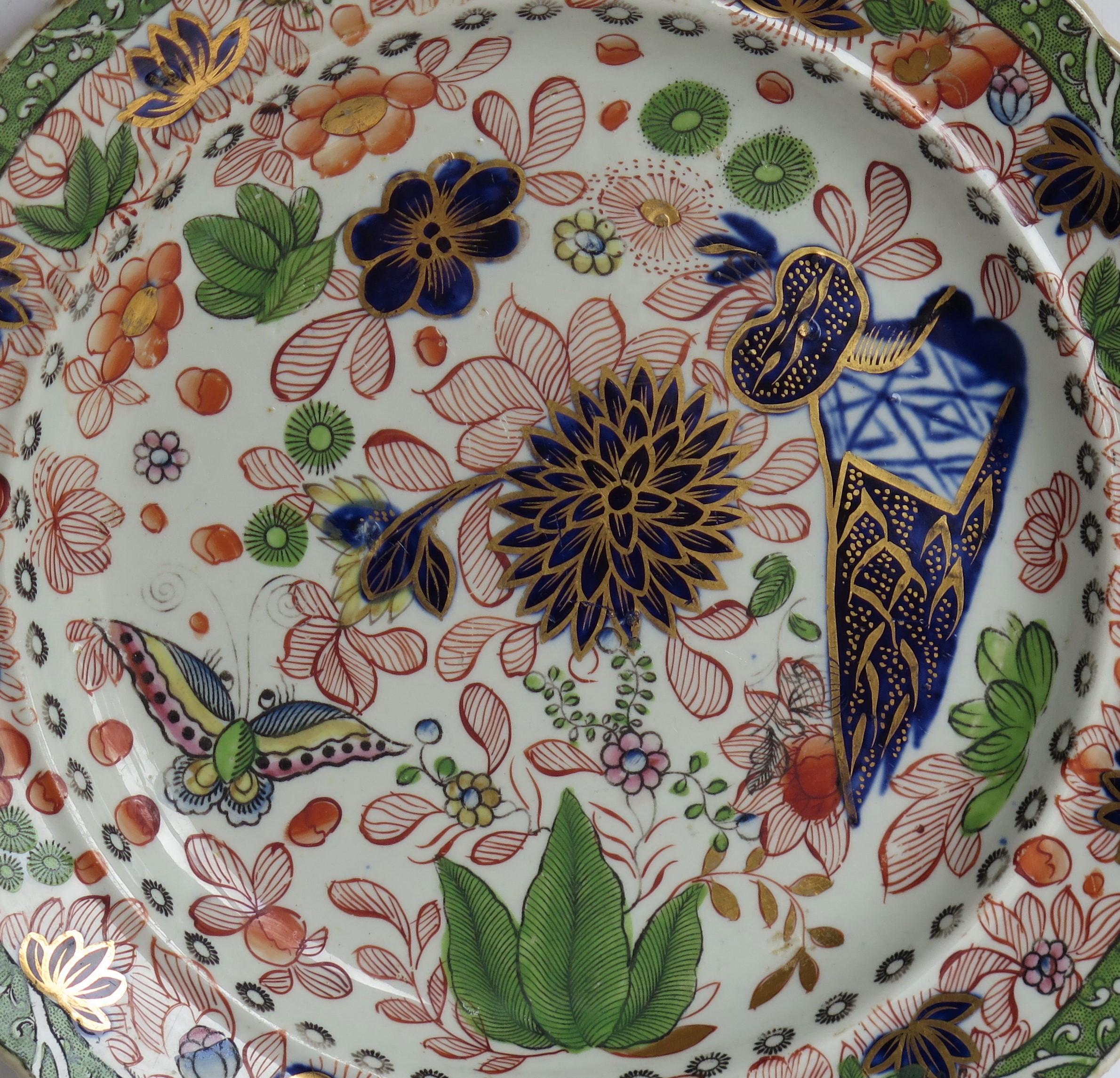This is a fine ironstone pottery side plate made by the Mason's factory at Lane Delph, Staffordshire, England and beautifully hand decorated in the Butterfly & Mazarine Chrysanthemum Pattern, fully stamped and dating to the earliest period of