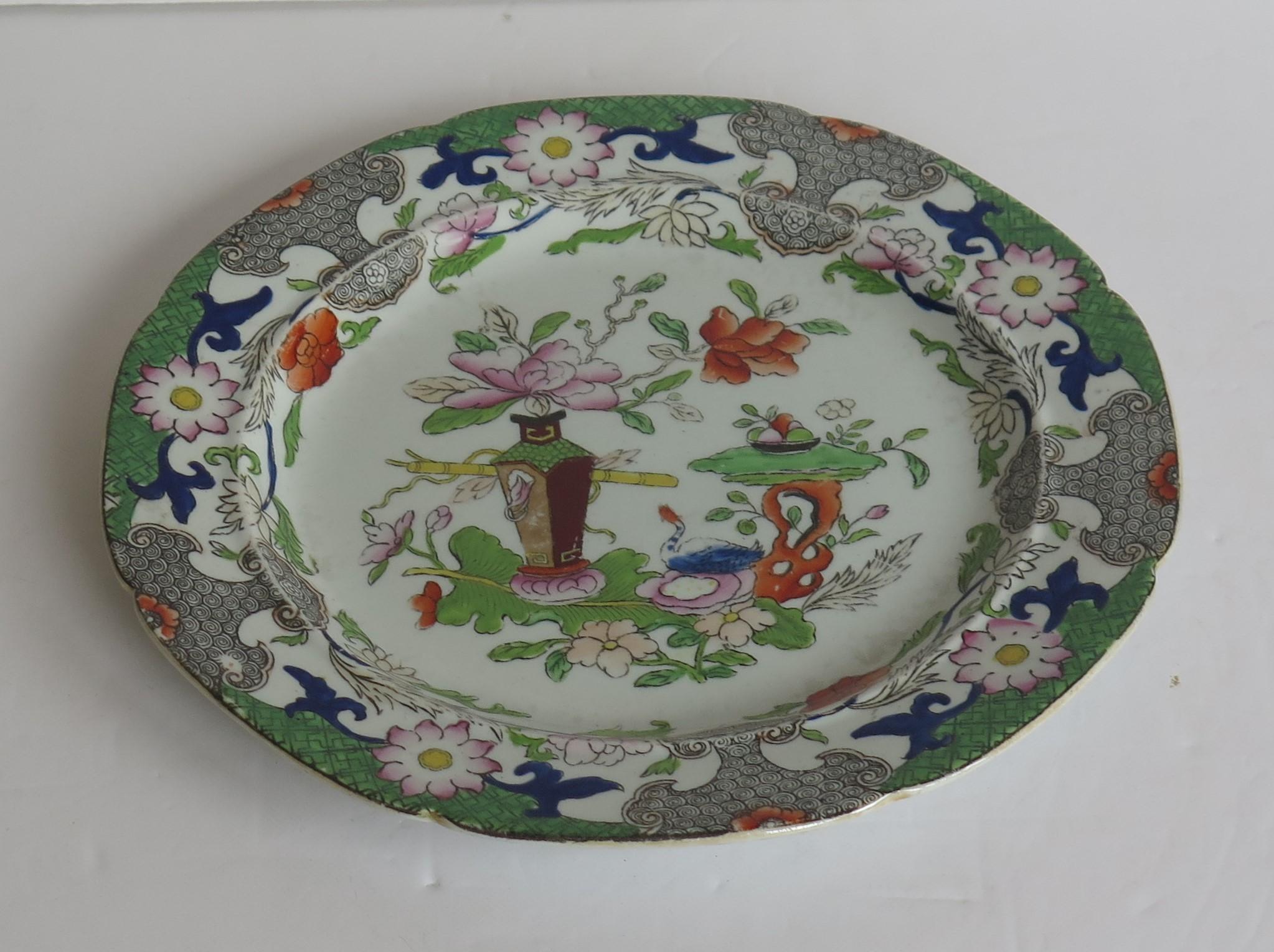 This is a hand-painted Mason's ironstone side plate, in the Table and Flower pot gilded pattern, from their earliest George 3rd period, circa 1818. 

This plate is well painted in the Chinoiserie pattern called the Table and Flower Pot pattern,