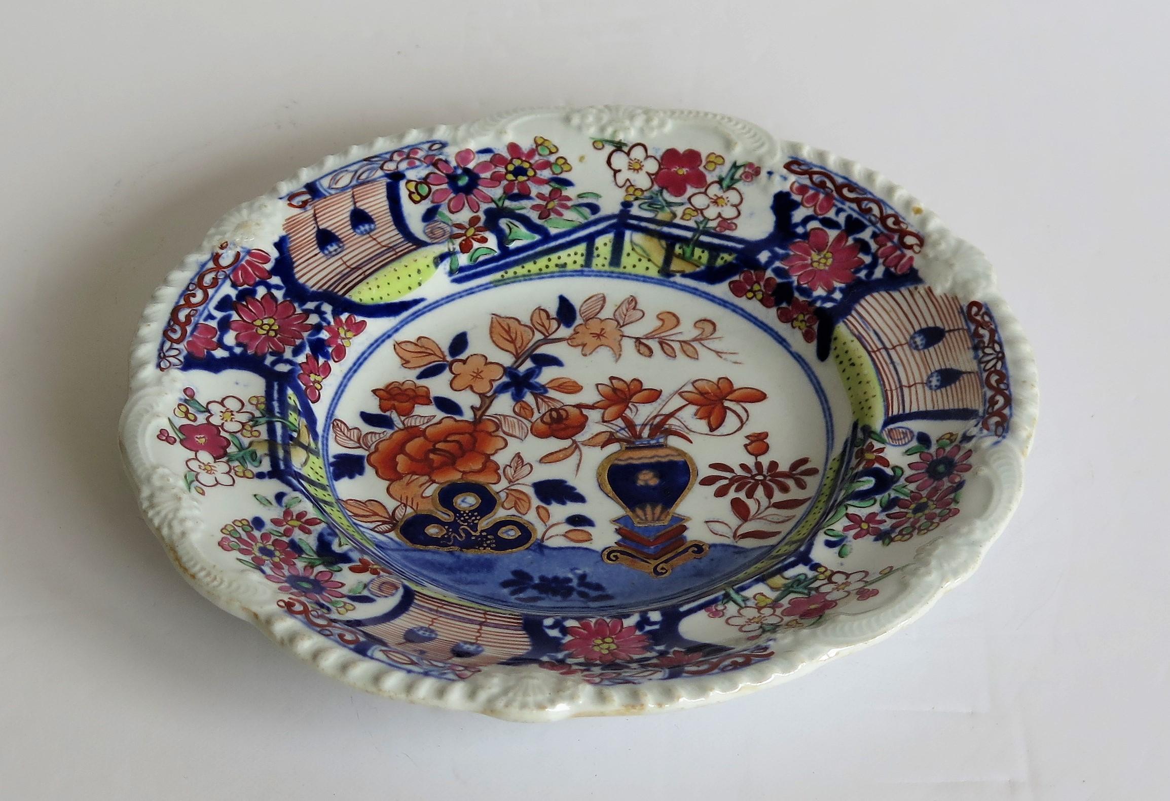 This is an early and very decorative ironstone pottery side plate or dish produced by the Mason's factory at Lane Delph, Staffordshire, England, circa 1815.

The plate is circular with an attractive pie crust edge moulding to the rim.

This