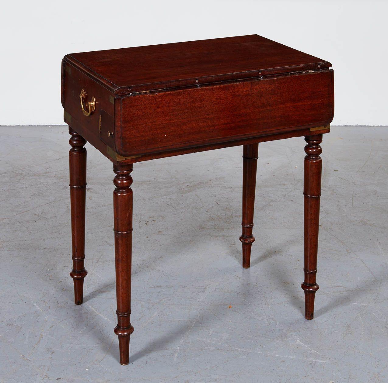 Rare English early 19th century mahogany campaign pembroke/writing table, having top and two drop leaves with thumb molded edge, with hinged top revealing a writing and dressing table, with leather topped writing slope and pewter lined pen and ink