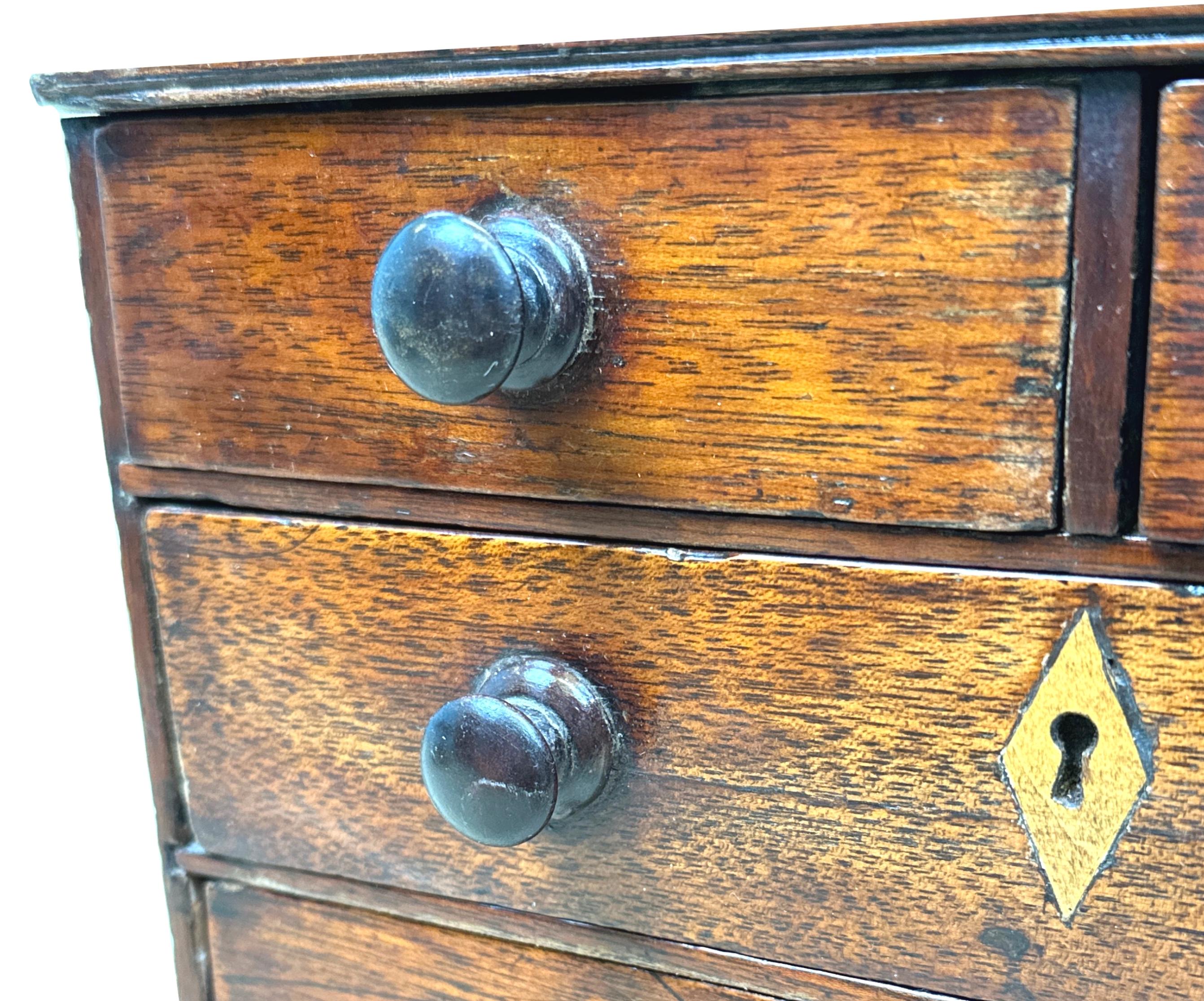 An Attractive 18th century Georgian, Mahoghany Miniature chest, having two short and three long drawers with original turned wooden knobs, raised on original shaped bracket feet.


Almost certainly made by an apprentice looking to showcase his