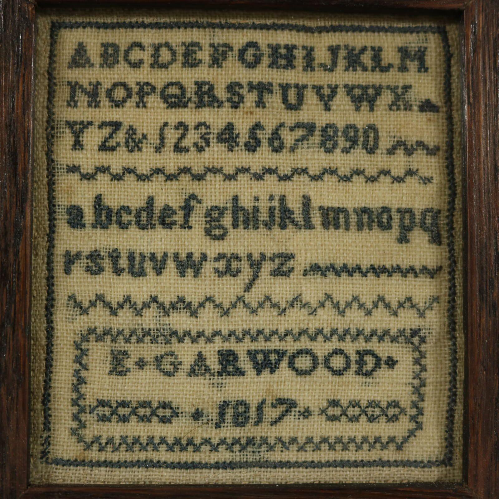 Georgian Miniature Sampler, 1817, by E Garwood. The sampler is worked in silk threads on a linen ground, mainly in cross stitch. Simple line border. Colours . Alphabets A-Z in upper case and lower case and numbers 0-9. Signed and dated, 'E GARWOOD