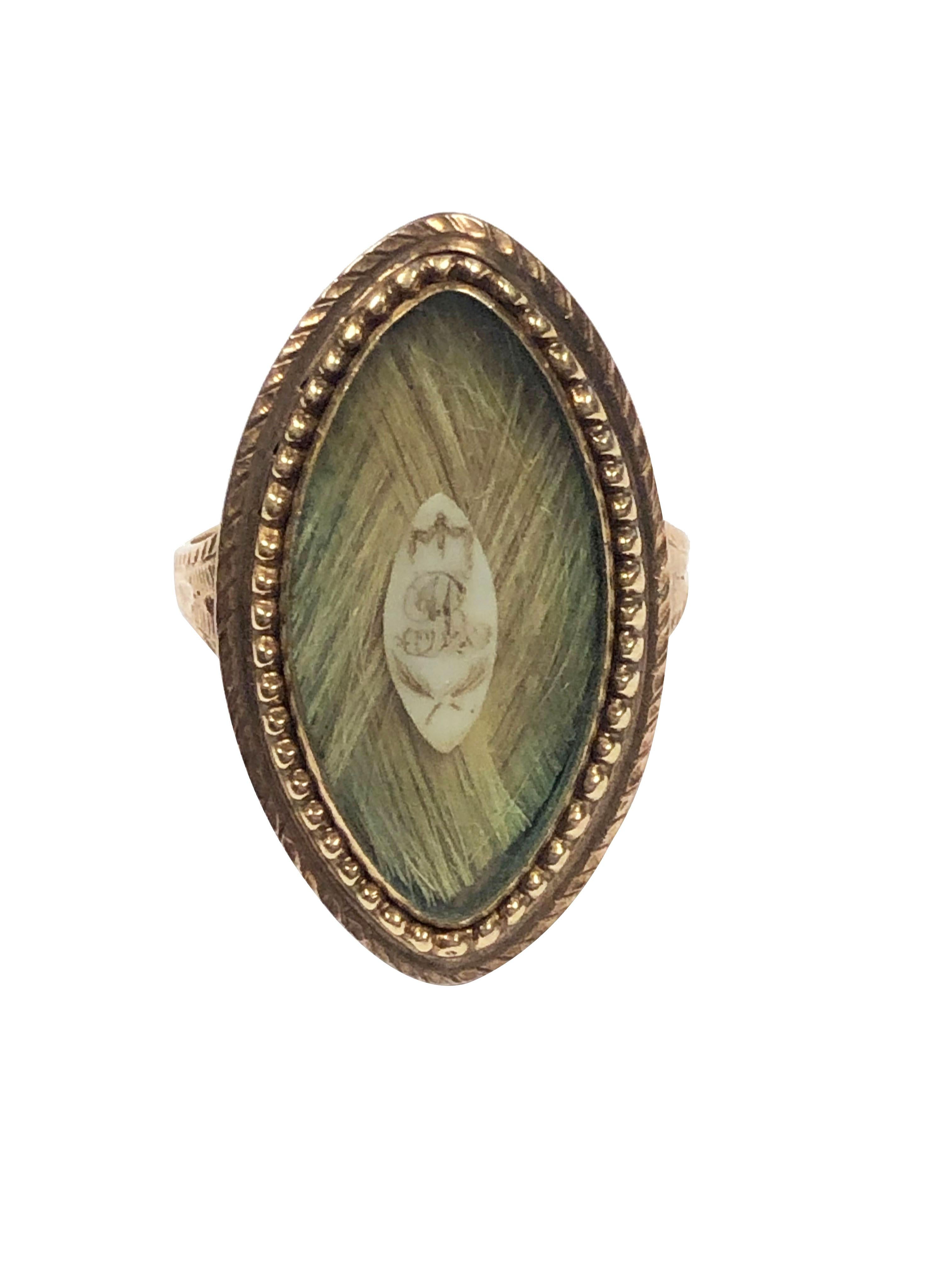 Circa 1850 14 - 15k Yellow Gold Mourning Memorial ring, in a Navette shape measuring 1 1/8 inch in length X 5/8 inch wide, light color woven hair with a center plaque with the letter 