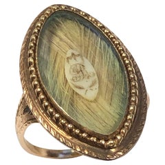 Anillo georgiano conmemorativo de luto de oro y navette de pelo