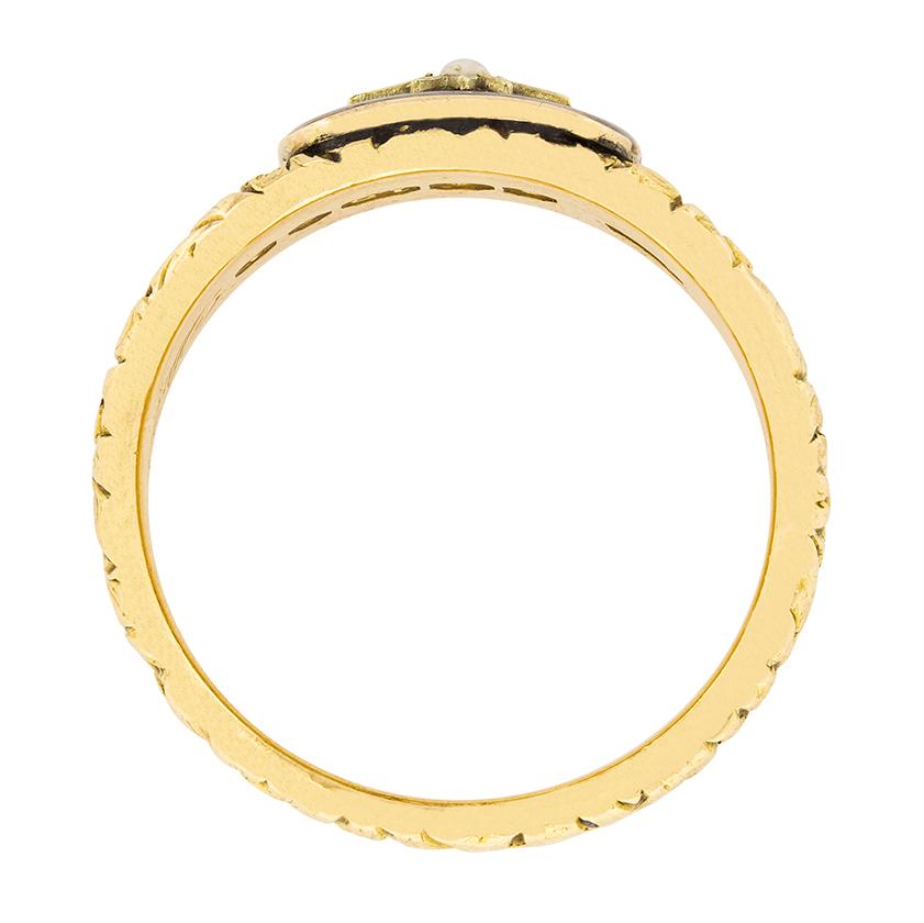 This Georgian ring is hallmarked 1824 and is engraved with the words 'Died Nov 3rd 1874'. This is an original mourning ring made in 18 carat yellow gold and covered with black enamel. There is a small natural pearl in the centre of the ring, and the