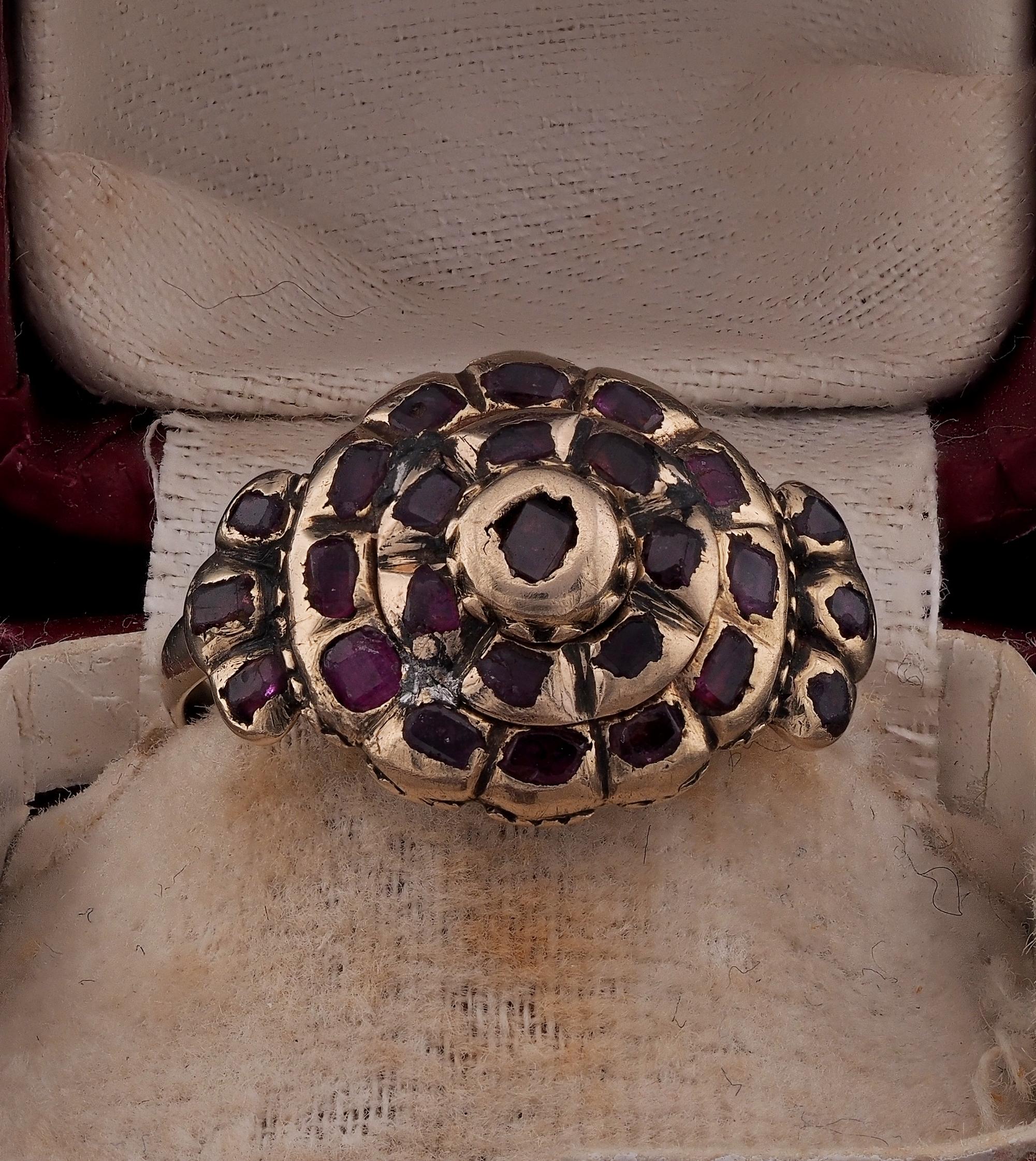 This antique Ruby ring is Georgian period, classy Iberian example of the era in a rosette shape – hand crafted of solid 18 KT gold, tests as 18/20 KT
It has a flat large crown set with a selection of table cut natural Rubies, tested, deep red