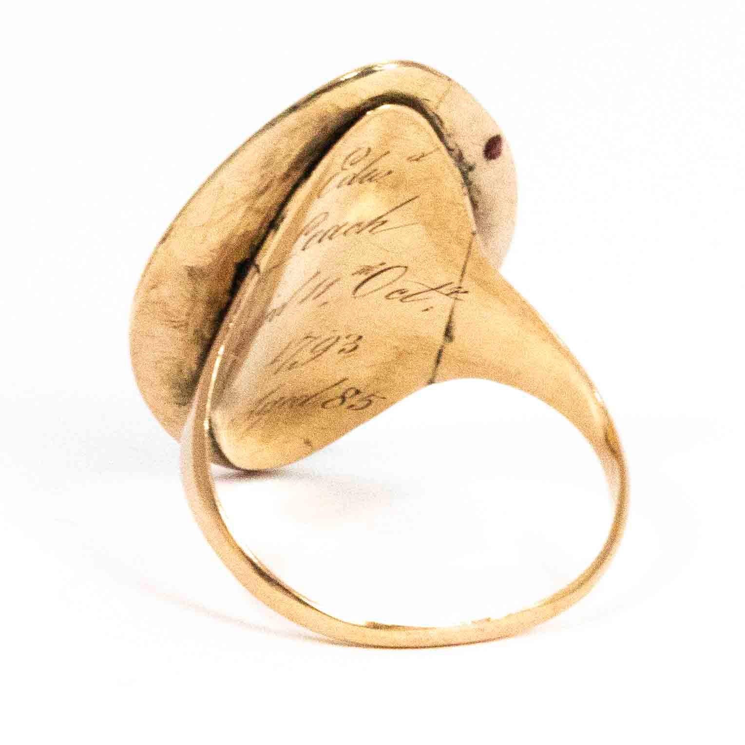 A spectacular antique Georgian mourning ring set with a stunning navette shaped sepia. The sepia features a scene with a woman in mourning by an urn below a weeping willow, the urn pedestal reads 