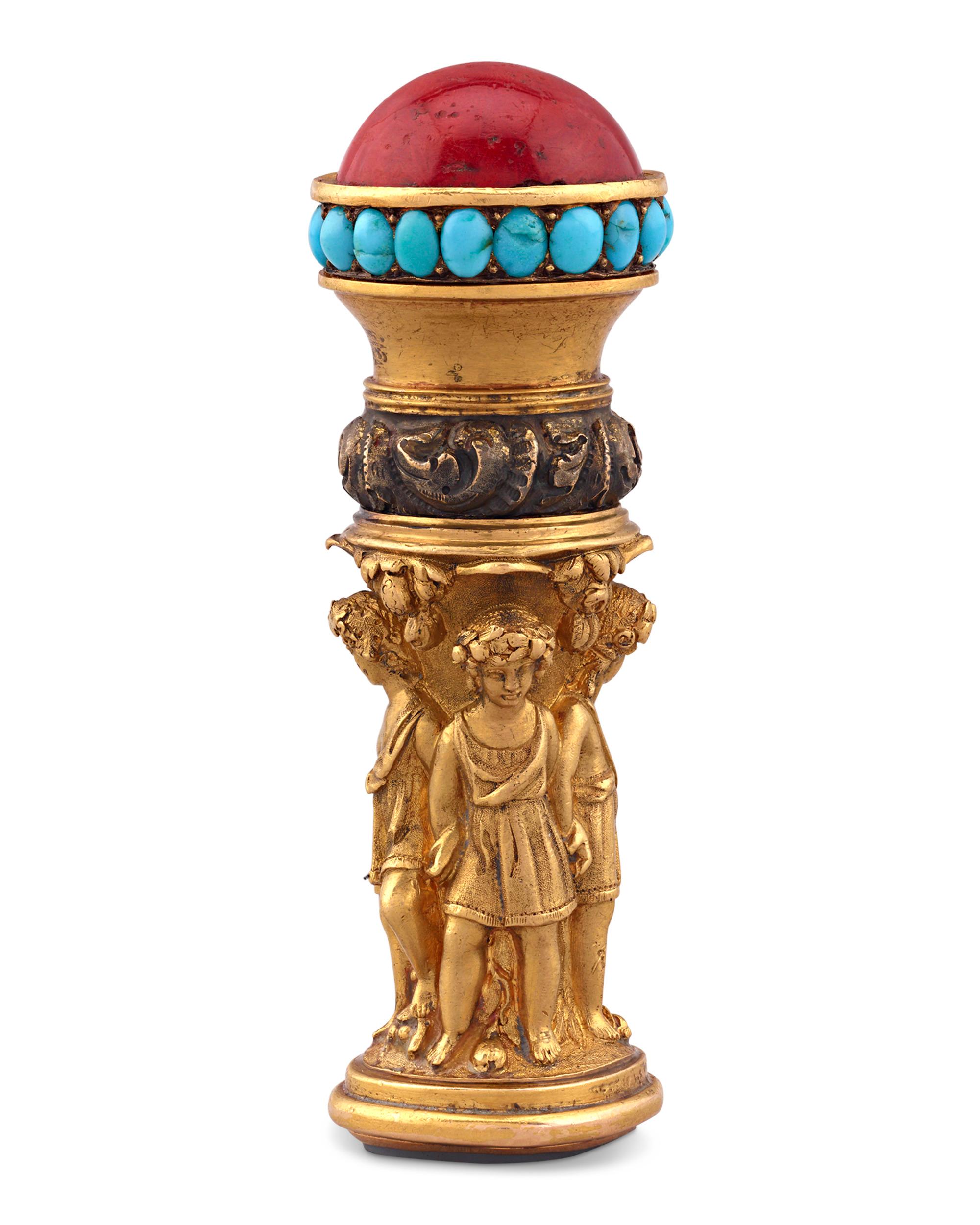 A neoclassical motif featuring five youths clad in togas are chased and repoussé into this opulent Georgian-period gold fob seal. The dome-shaped handle is inlaid with brilliant red coral and sky-blue turquoise cabochons, lending vibrancy to this