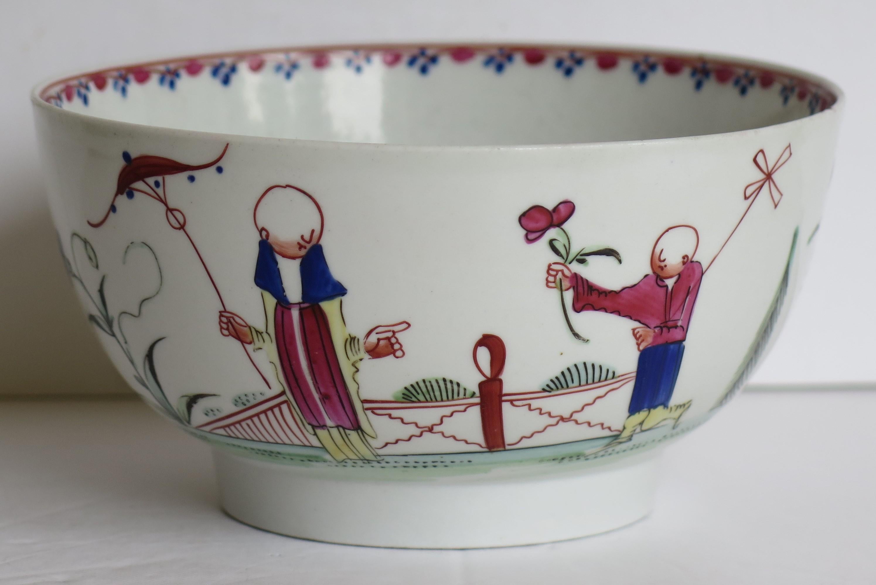 This is a hard paste porcelain waste or slop bowl by New Hall in a hand painted Chinoiserie figure pattern No. 20, dating to the late 18th century, circa 1790.

The bowl is well potted on a mid depth foot. 

The decoration is hand-painted using