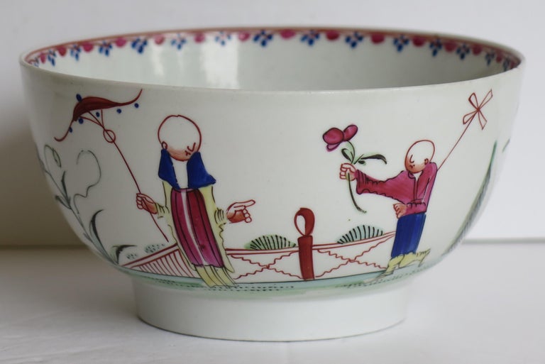 This is a hard paste porcelain waste or slop bowl by New Hall in a hand painted Chinoiserie figure pattern No. 20, dating to the late 18th century, circa 1790.

The bowl is well potted on a mid depth foot. 

The decoration is hand-painted using