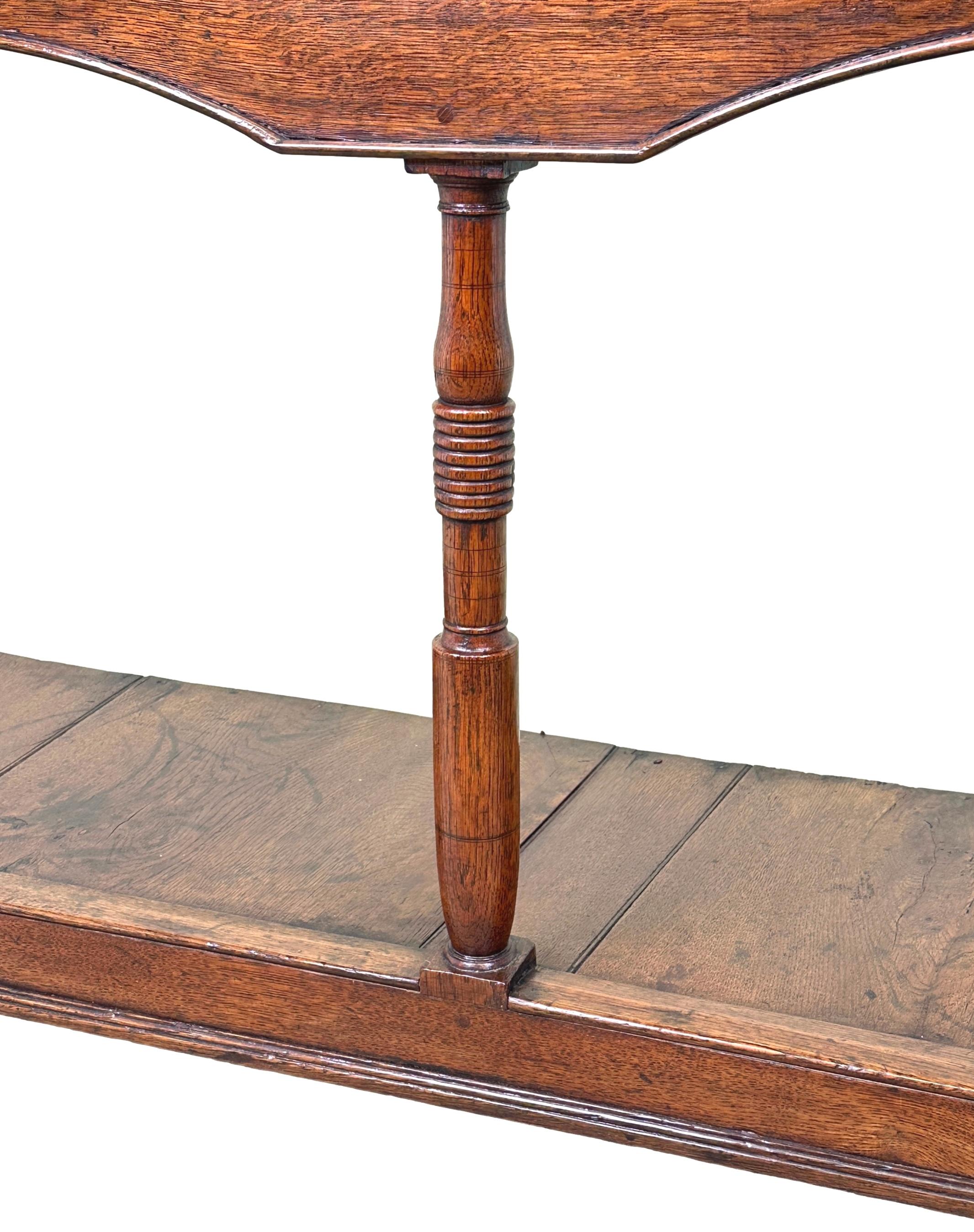 A Very Attractive Late 18th Century George III Period Oak Dresser Base, Of Relatively Small & Compact Proportions, Having Well Figured Top Over Three Drawers With Replacement Brass Knobs To Arched Frieze, Raised On ELegant Turned Upright Supports