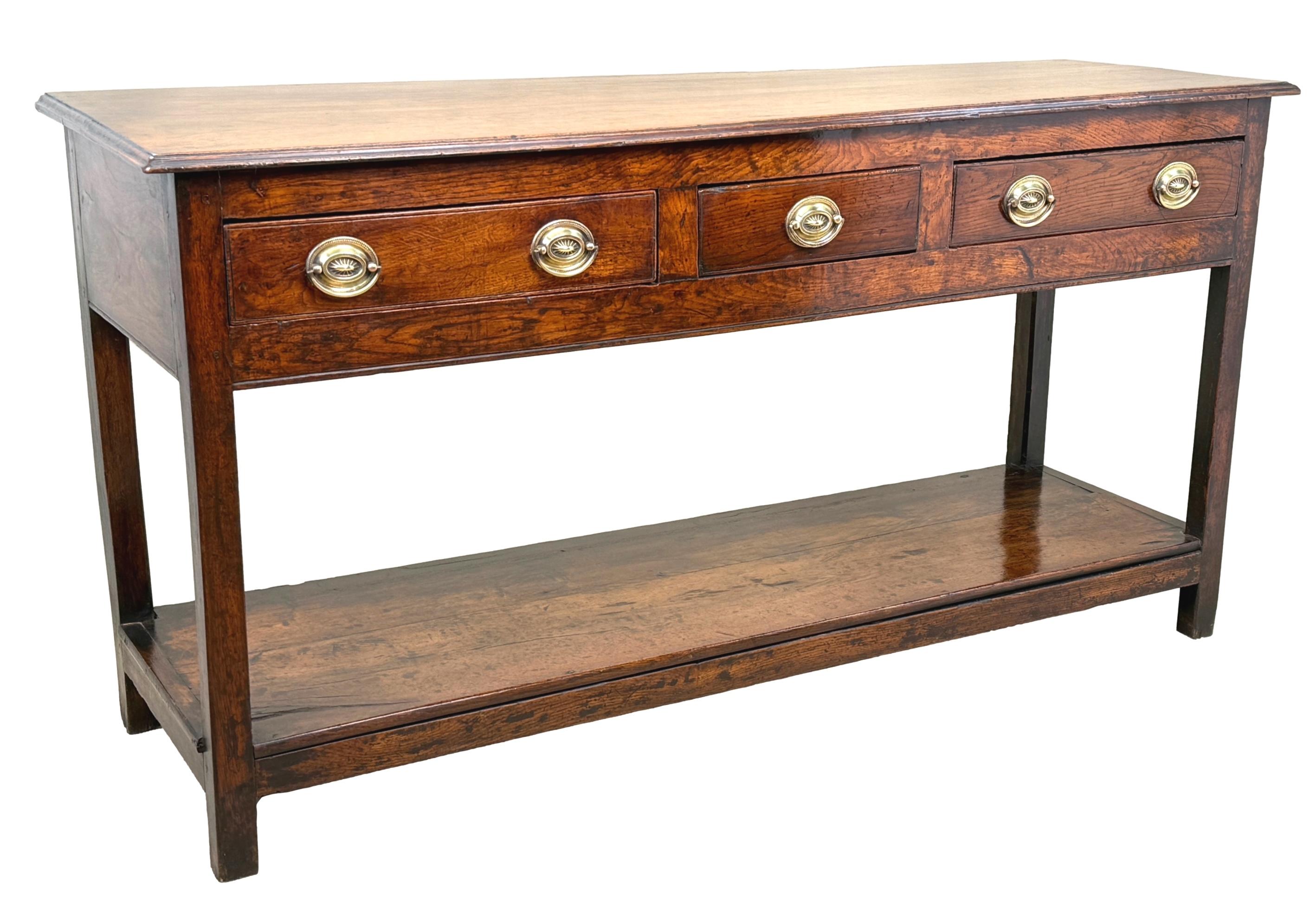 A Charming Mid 18th Century, George II Period, Oak Dresser Base, Or Sideboard, Of Relatively Small Proporrtion, Retaining Excpetional Rich Colour Throughout, Having Rectangular Top Over Three Drawers To Frieze, With Replacement Brass Oval Plate