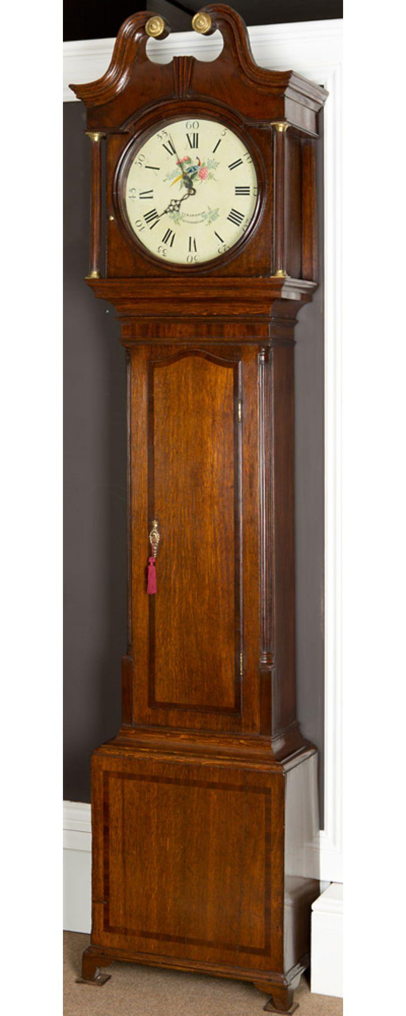 Georgian Oak and Mahogany Longcase clock.
 
The case is made from the finest English oak and crossbanded with mahogany, it has reeded canted corners either side of the trunk door also with reeded pillars either side of the hood door with brass