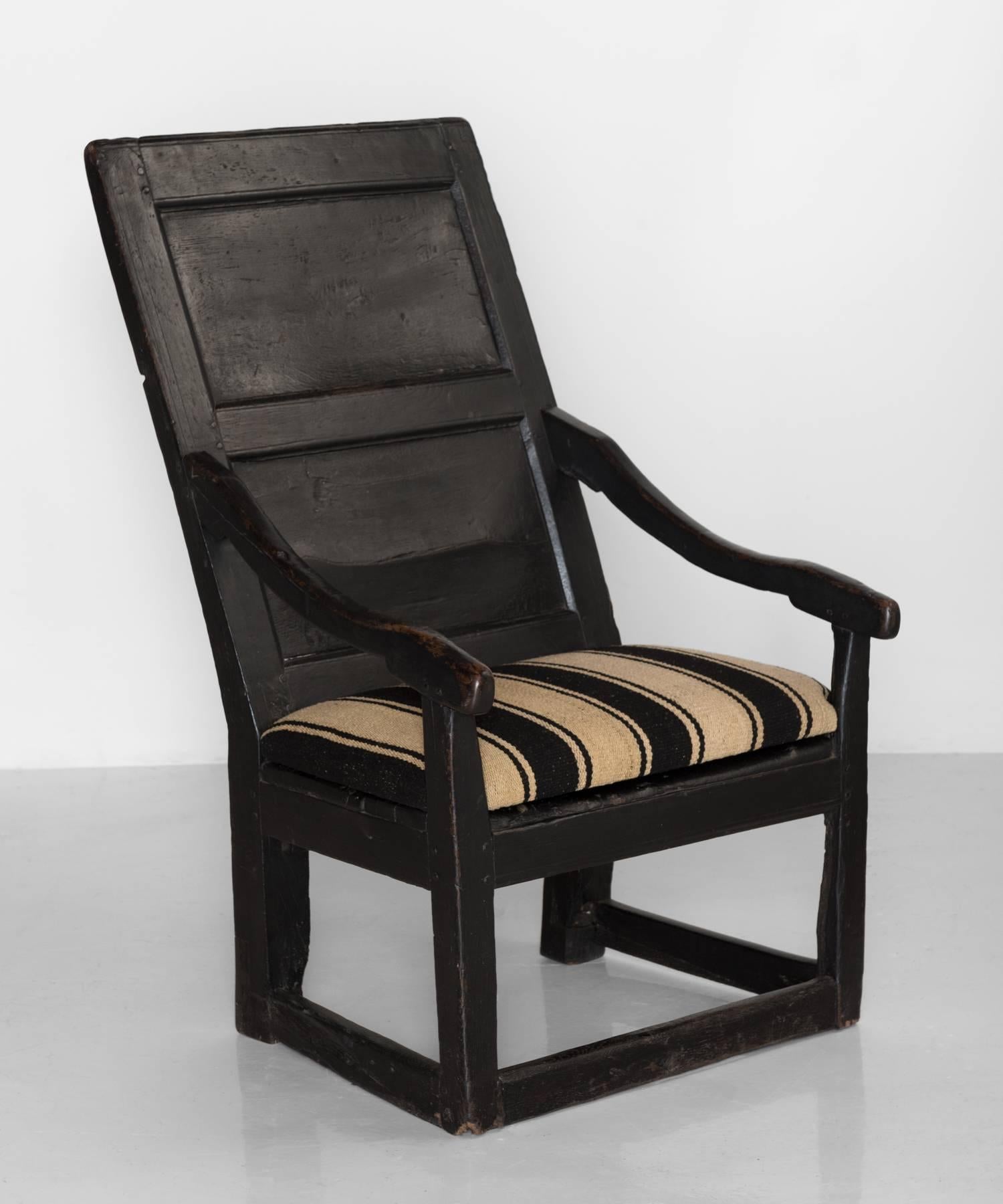 Georgian oak armchair, Wales, circa 1790.

Country armchair with panelled back and early black paint finish. Seat upholstered in an antique horse blanket.

Measures: 24