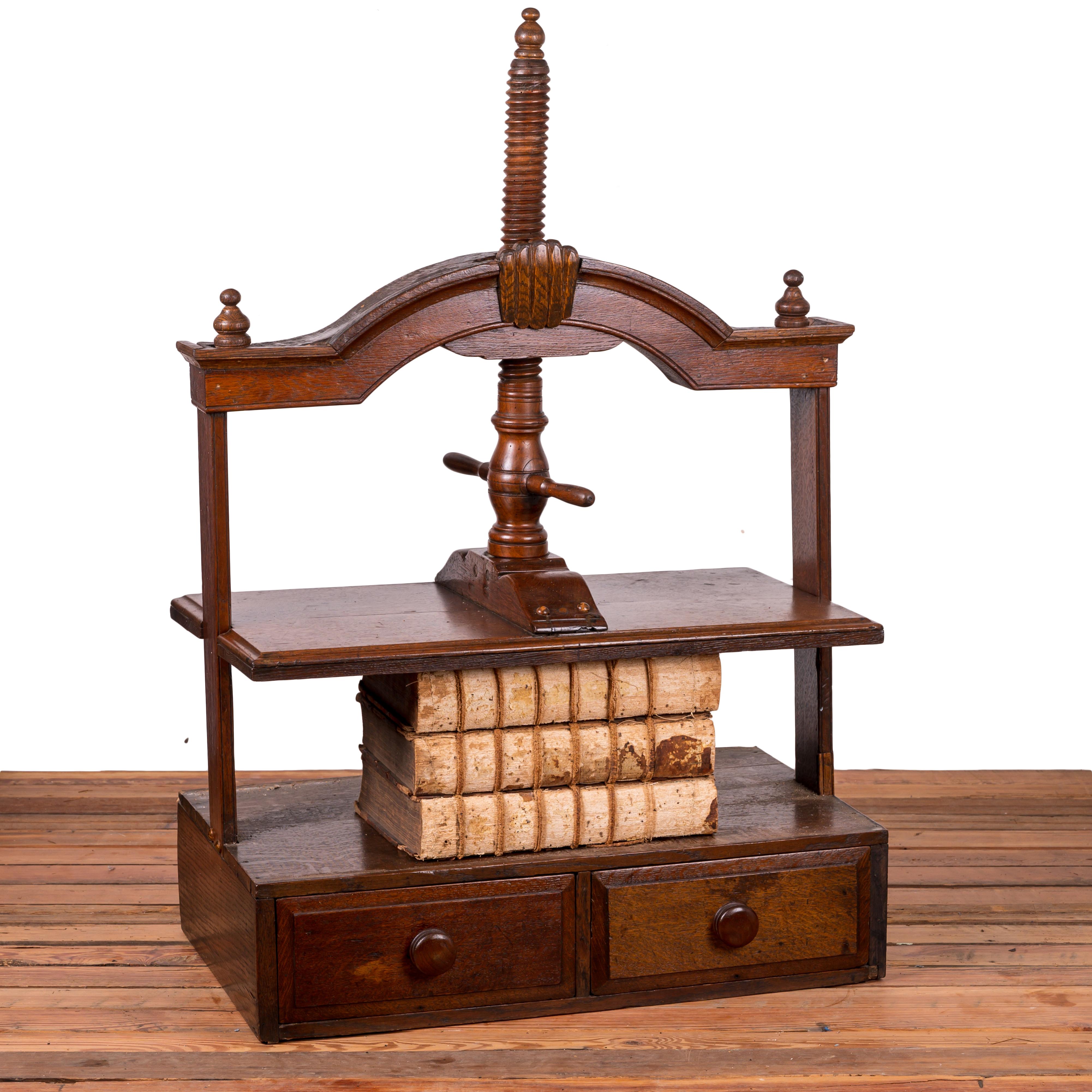 An 18th century George III oak book press with two drawers.

32 ½ inches wide by 20 inches deep by 36 inches tall

