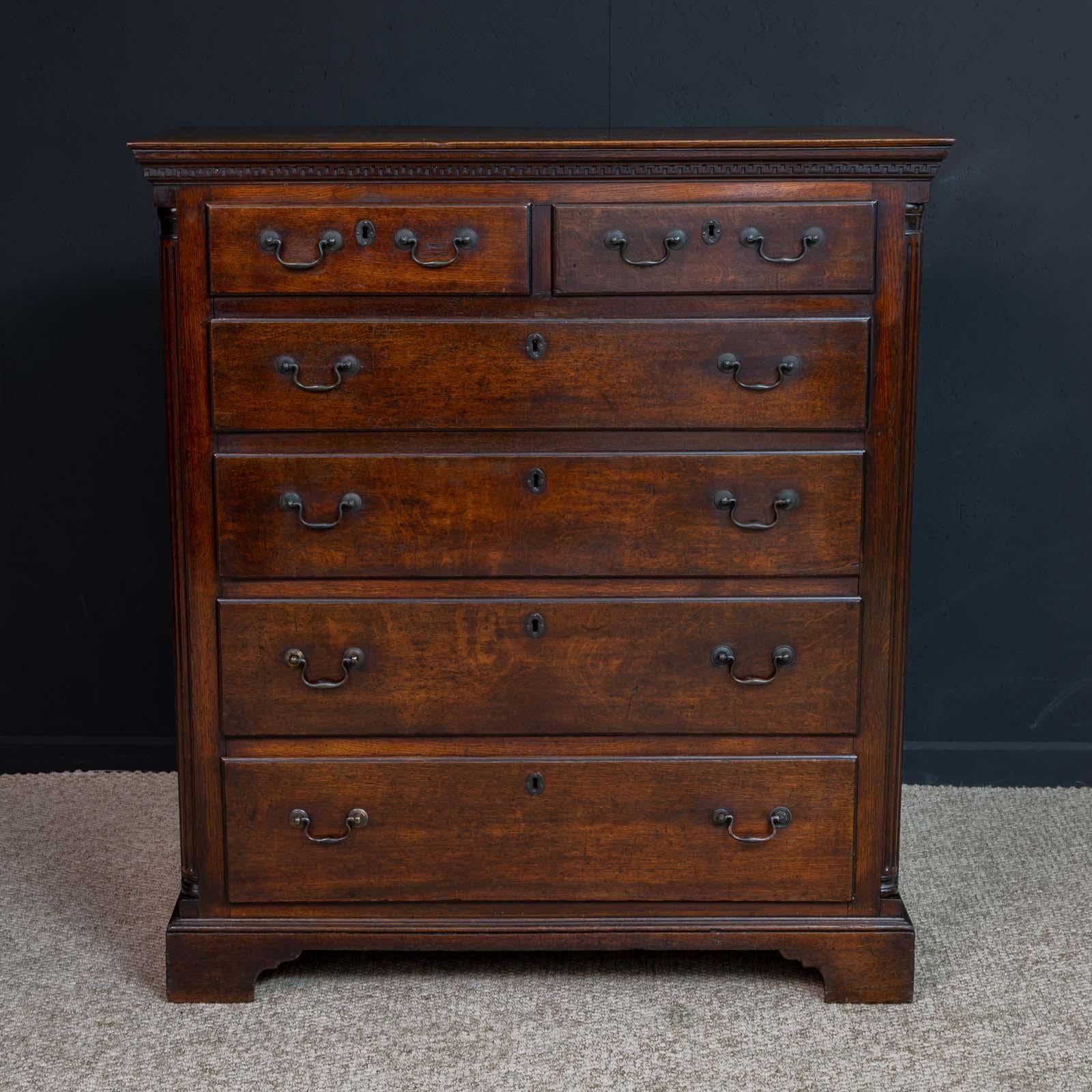 A superb mid-18th century oak chest of drawers of a beautiful rich color and patina. Very original with only minor repairs over it's 270 years. Sat on bracket feet with reeded canted corners and lovely terminals. Just beneath the top is a blind fret