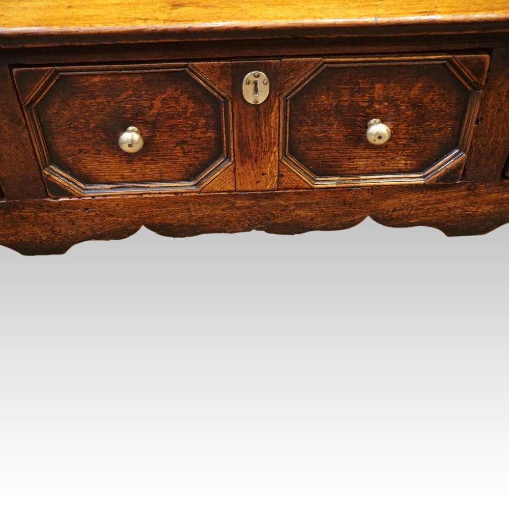 Antique long oak dresser base
This Antique long oak dresser base was made circa 1800 and of pegged construction.
The impressive oak dresser base is fitted 3 drawers with geometric mouldings around the drawers, all fitted with the cast brass drawer