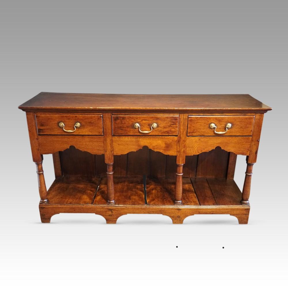 Antique oak dresser base
This charming Antique oak dresser base was made circa 1820.
It is of a good small size and so will fit in most spaces in your home.
It is fitted 3 drawers all with the brass swing handles.
Under the drawers are the finely