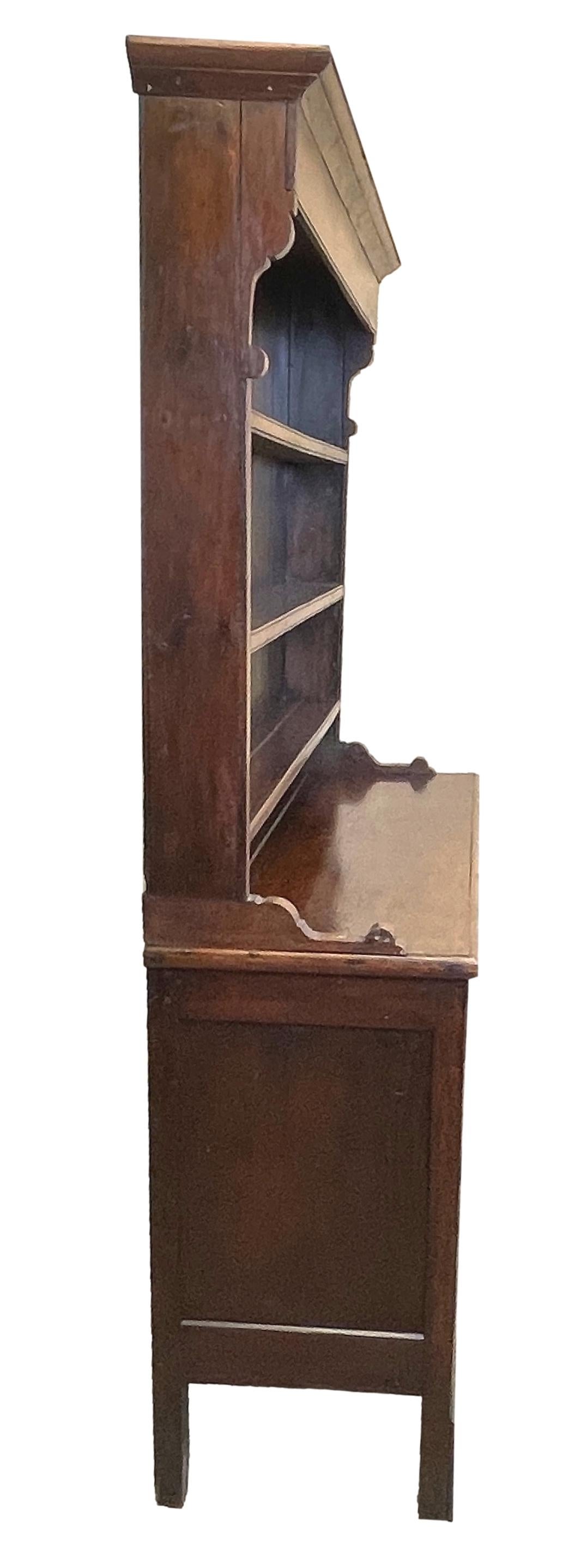 A good quality early 19th century Georgian oak dresser having original shaped canopy rack with three shelves over three drawers to frieze and three false drawers flanked by panelled cupboard doors with replacement turned brass knobs raised on