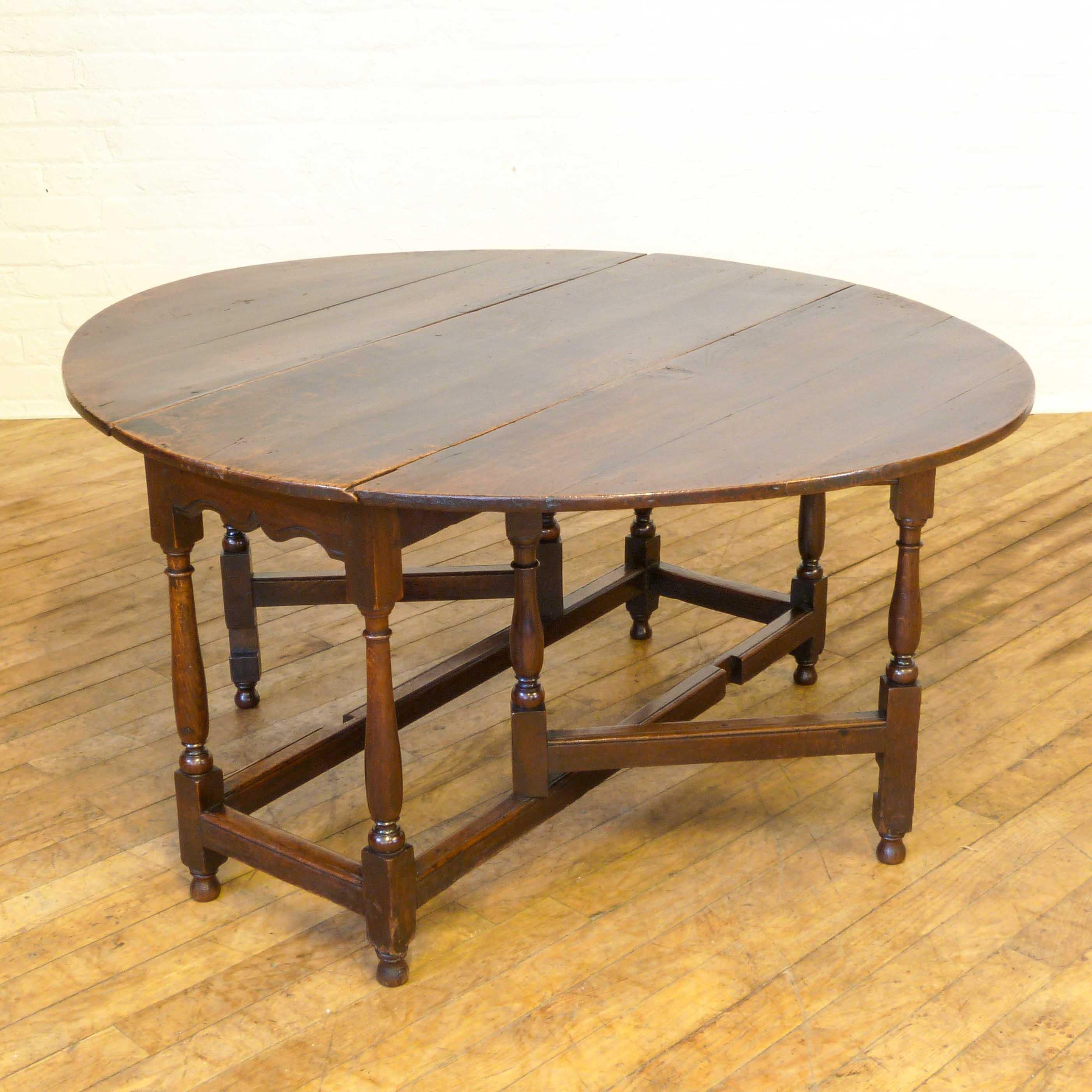 With a lovely original patina, this antique Georgian oak gateleg table has a typical design that has survived through the ages. A small but significant bonus is the attractively shaped apron to the ends, which is quite unusual. The table itself is