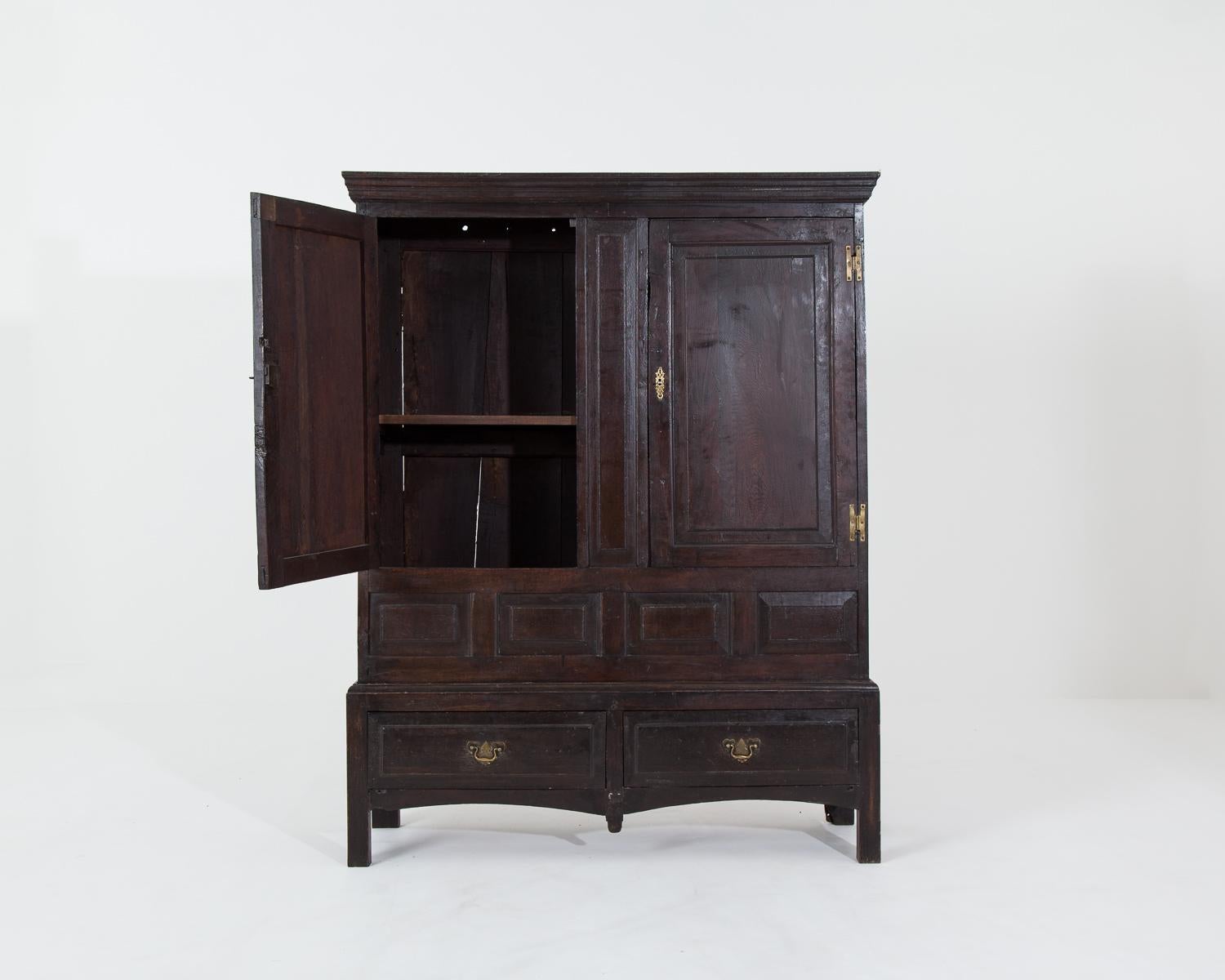 Substantial 18th century oak livery cupboard.

The piece includes some of the original pegs, probably once used for hanging tack and original hand painted wallpaper on the back of the cupboard. A modern shelf has been added at some point to make