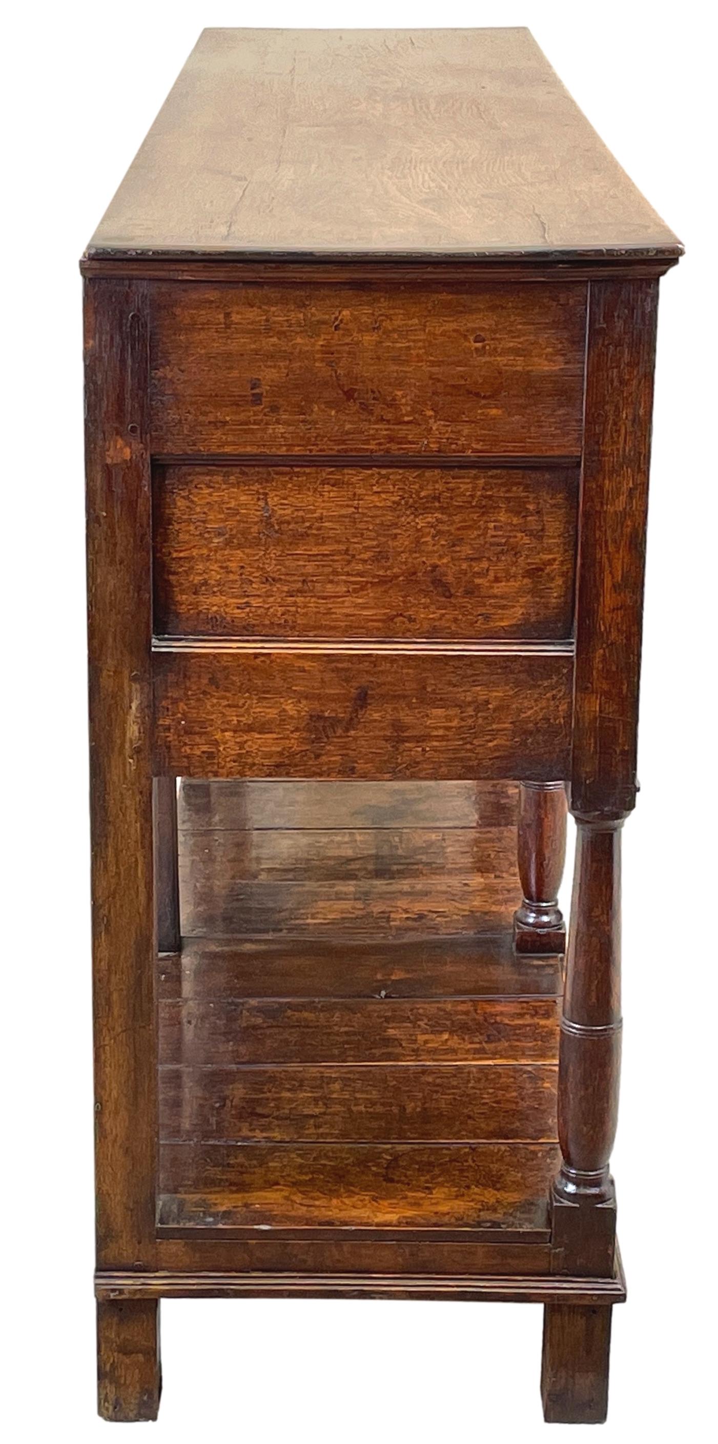 A Very Attractive And Good Quality Late 18th Century Georgian Oak Dresser Base, Retaining Good Colour And Patina Throughout, Having Five Drawers, To Elegant Arched Frieze, With Replacement Brass Handles, Raised On Turned Upright Supports With