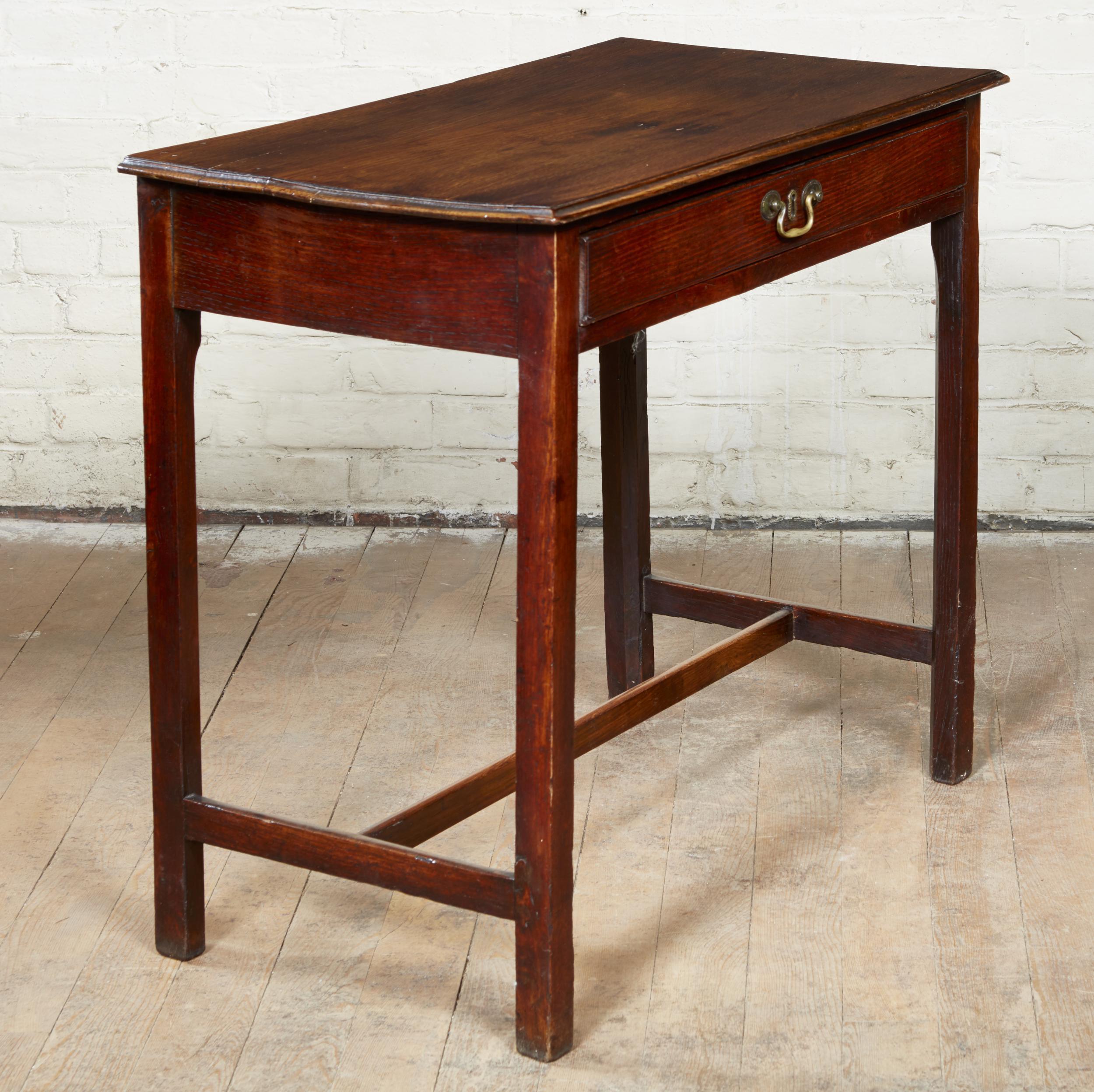 George III oak side table having an ogee molded top over single drawer, the square legs joined by 