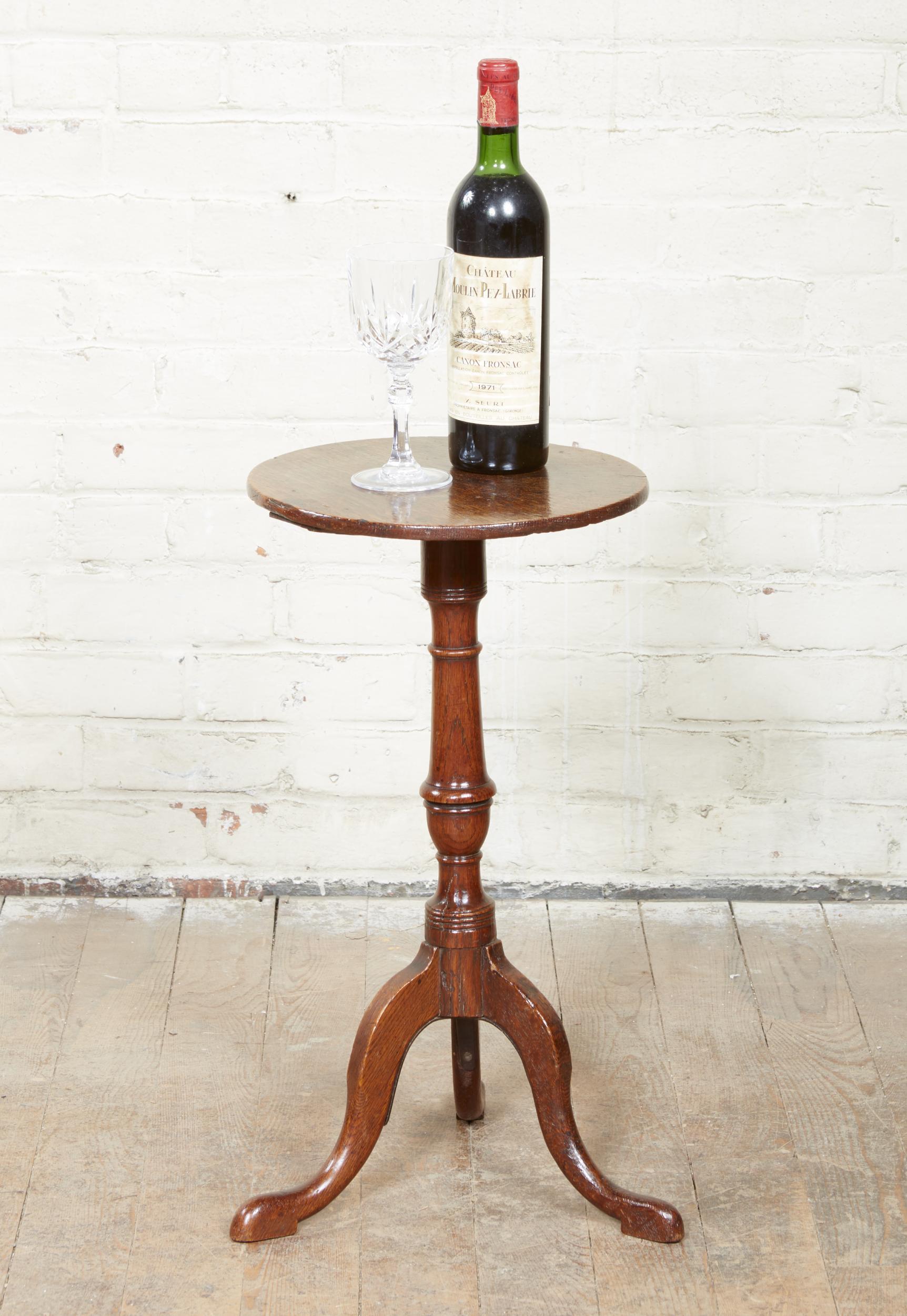 Fine George III oak wine table, the simple circular top with rounded edge, over classically turned shaft and standing on well shaped cabriole legs ending in slipper feet, the whole with good rich color and patina.