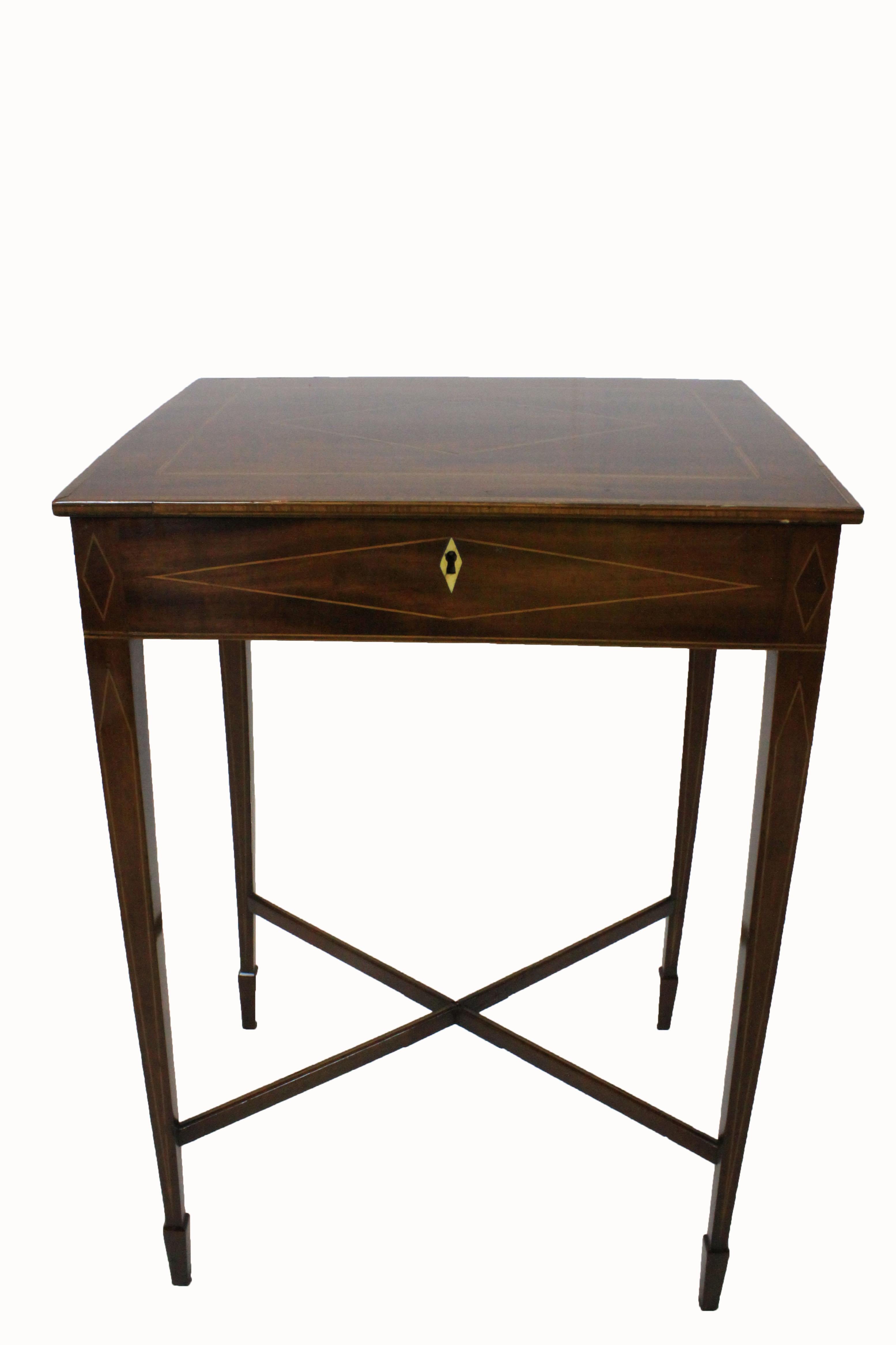 George III mahogany inlaid occasional table standing on square tapered legs ending in spade feet with cross stretchers. The lift top features boxwood stringing, narrow crossbanding and a boxwood and satinwood diamond shaped inlay. The diamond design