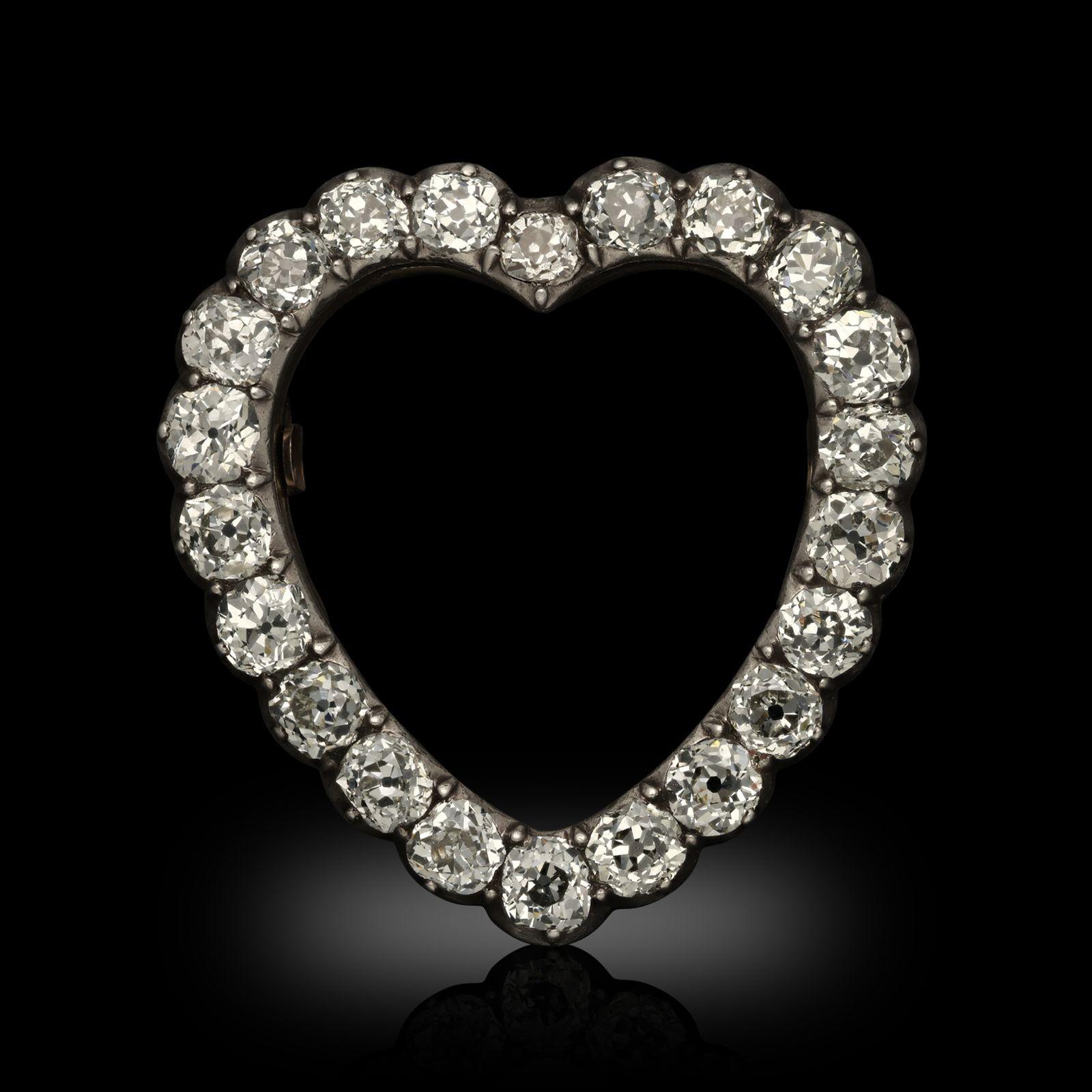 An antique old cut diamond heart brooch, circa 1820. The Georgian brooch is designed as an open heart shape, set with twenty-two old European cut diamonds all mounted in silver and gold with a single pin fitting to the reverse.
Period
Georgian circa