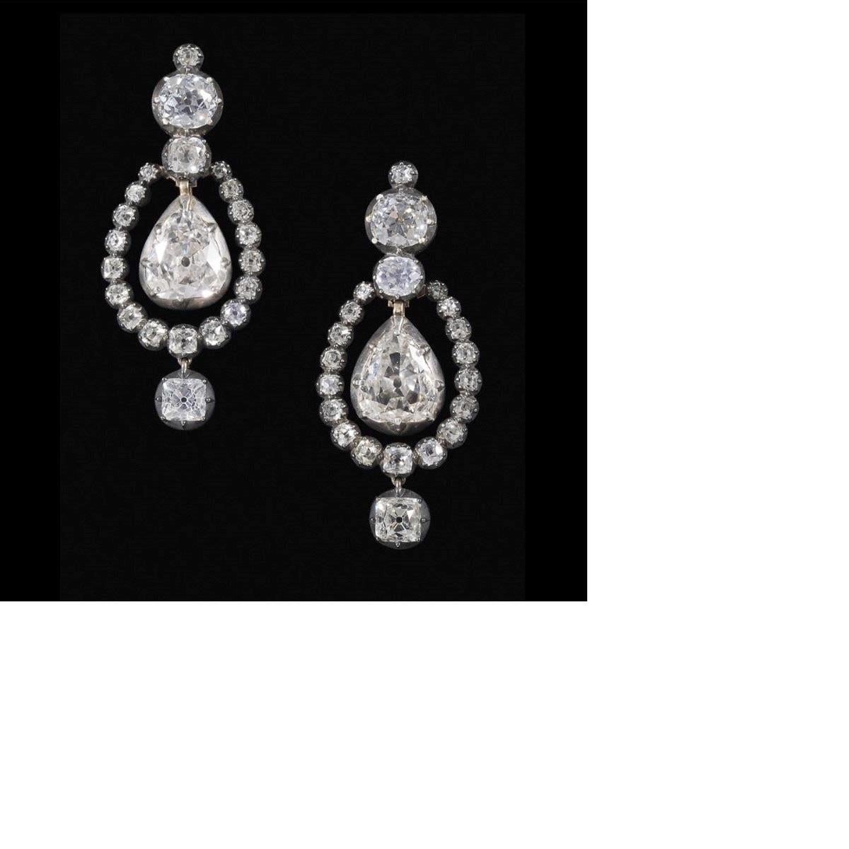A pair of Georgian 15 karat gold and silver earrings with diamonds. The earrings contain an approximate total diamond weight of 21.50 carats; 2 modified pear cut diamonds weighing 4.61 carats, K color, I1 clarity, GIA report #5181908769 and 5.08