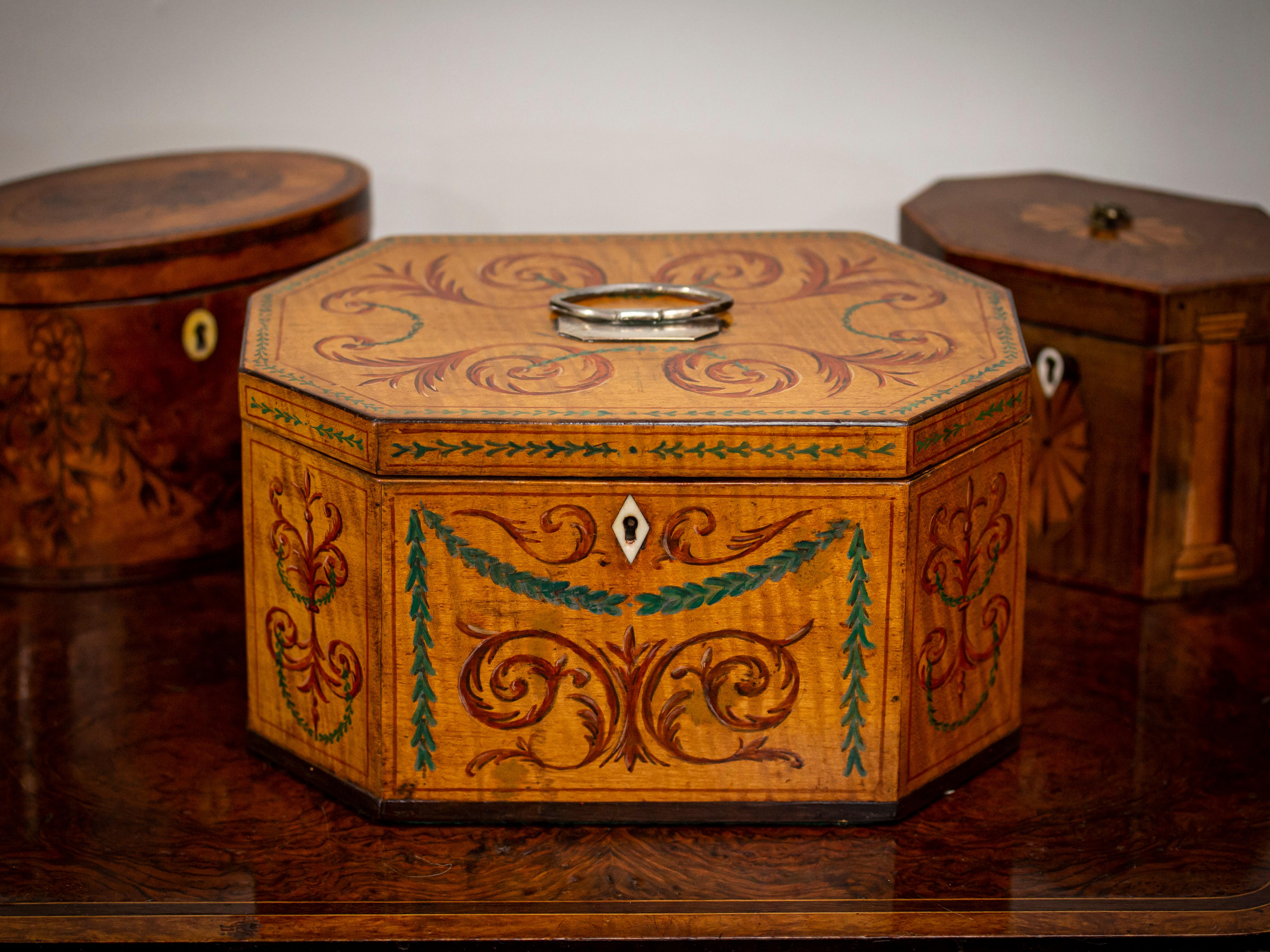 George III Circa 1785

From our Tea Caddy collection, we are delighted to offer this Rare Original Hand-Painted Sycamore Tea Caddy. The Tea Caddy of Octagonal form veneered in Sycamore with the original hand-painted panels featuring Green swags and