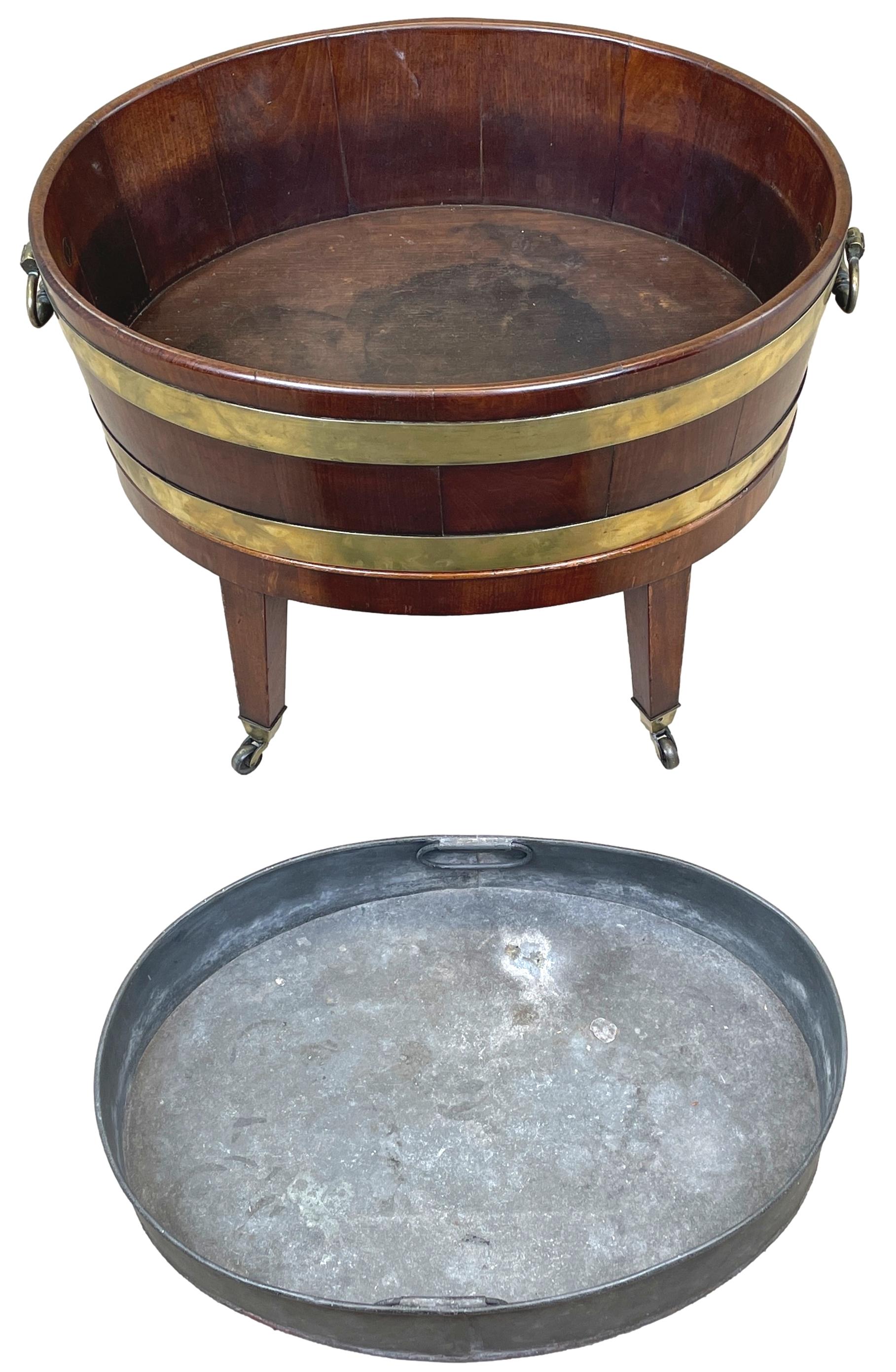 A Very Attractive 18th Century Georgian Mahogany Oval Shaped Open Wine Cooler Retaining Good Colour And Patina, With Original Brass Bound Decoration And Original Brass Handles, Raised On Elegant Original Stand With Square Tapered Legs And Original