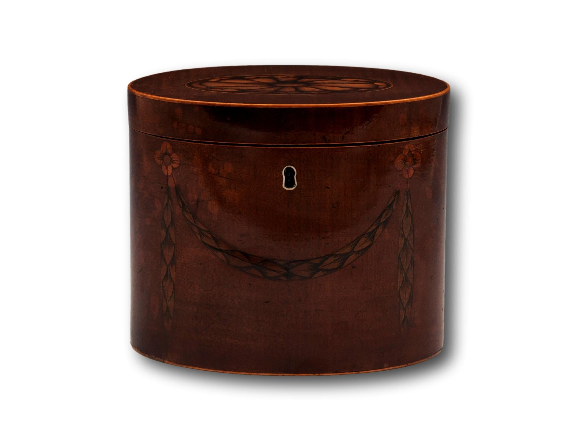From our Tea Caddy collection, we are delighted to offer this Georgian Oval Tea Caddy. The Tea Caddy of elongated Oval form veneered in Harewood with Boxwood stringing to the lid around the perimeter. The front of the Tea Caddy features a tied husk