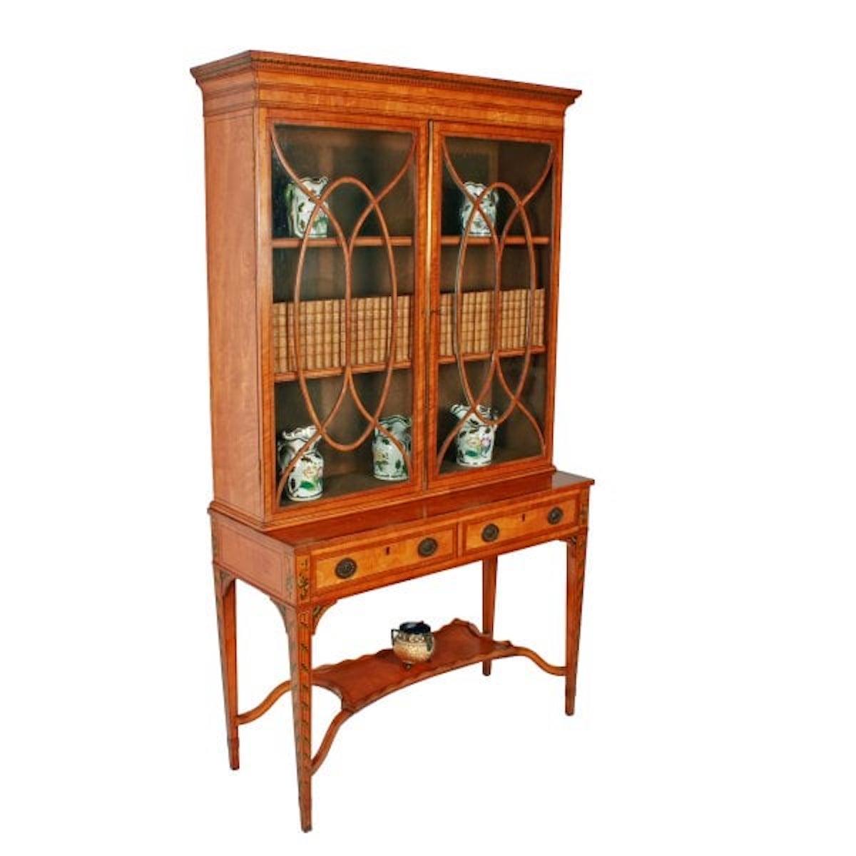 Georgian Painted Satinwood Cabinet

An early 19th century Georgian satinwood cabinet bookcase on a two drawer stand.

The cabinet is ebony strung, mahogany cross banded, and decorated with hand painted foliage and other decorations.

The