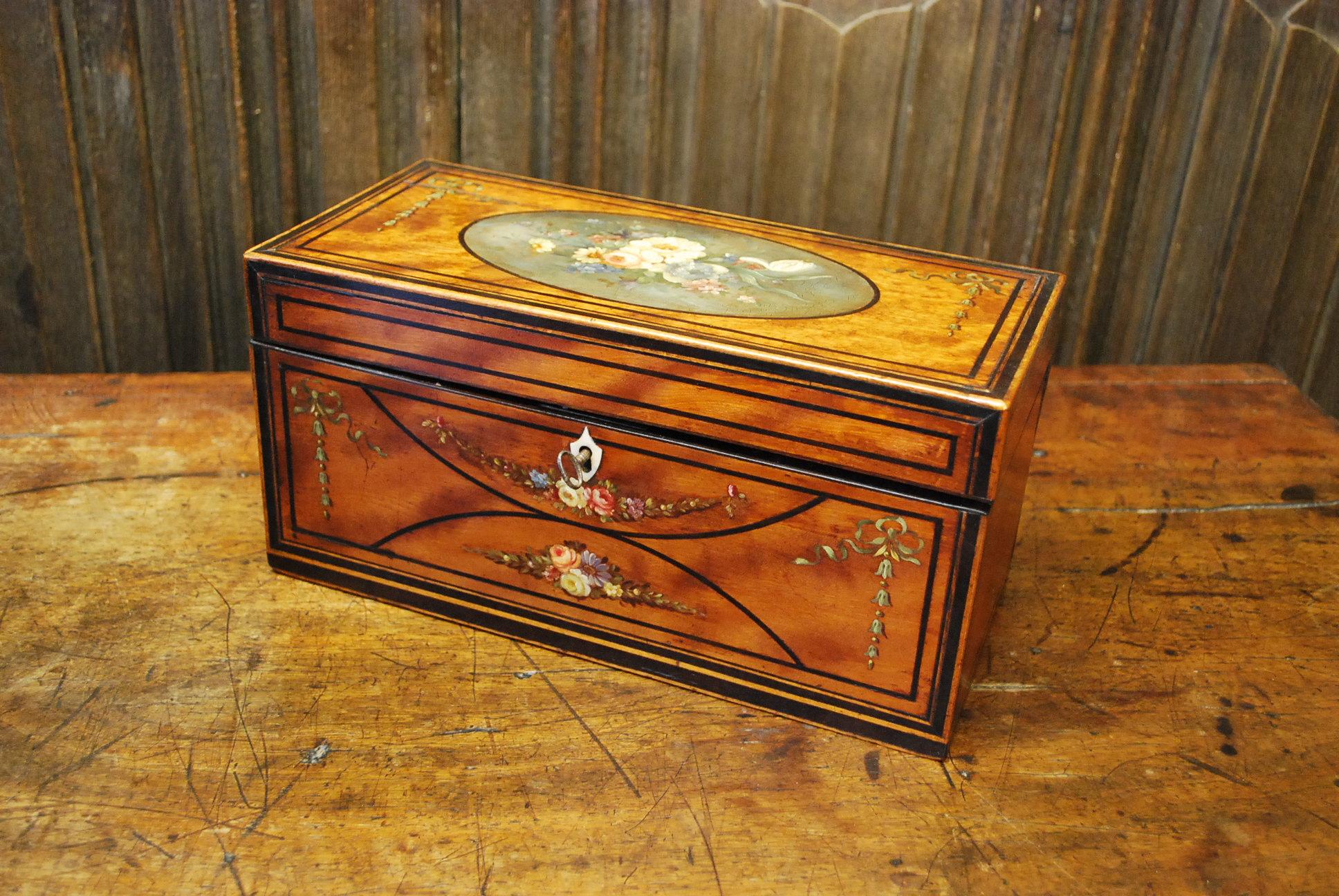 Hutton-Clarke Antiques is delighted to present an exquisite Georgian-painted satinwood Tea Caddy, crafted around 1790. This tea caddy is a true work of art, adorned with original floral festoons that have gracefully stood the test of time.

What