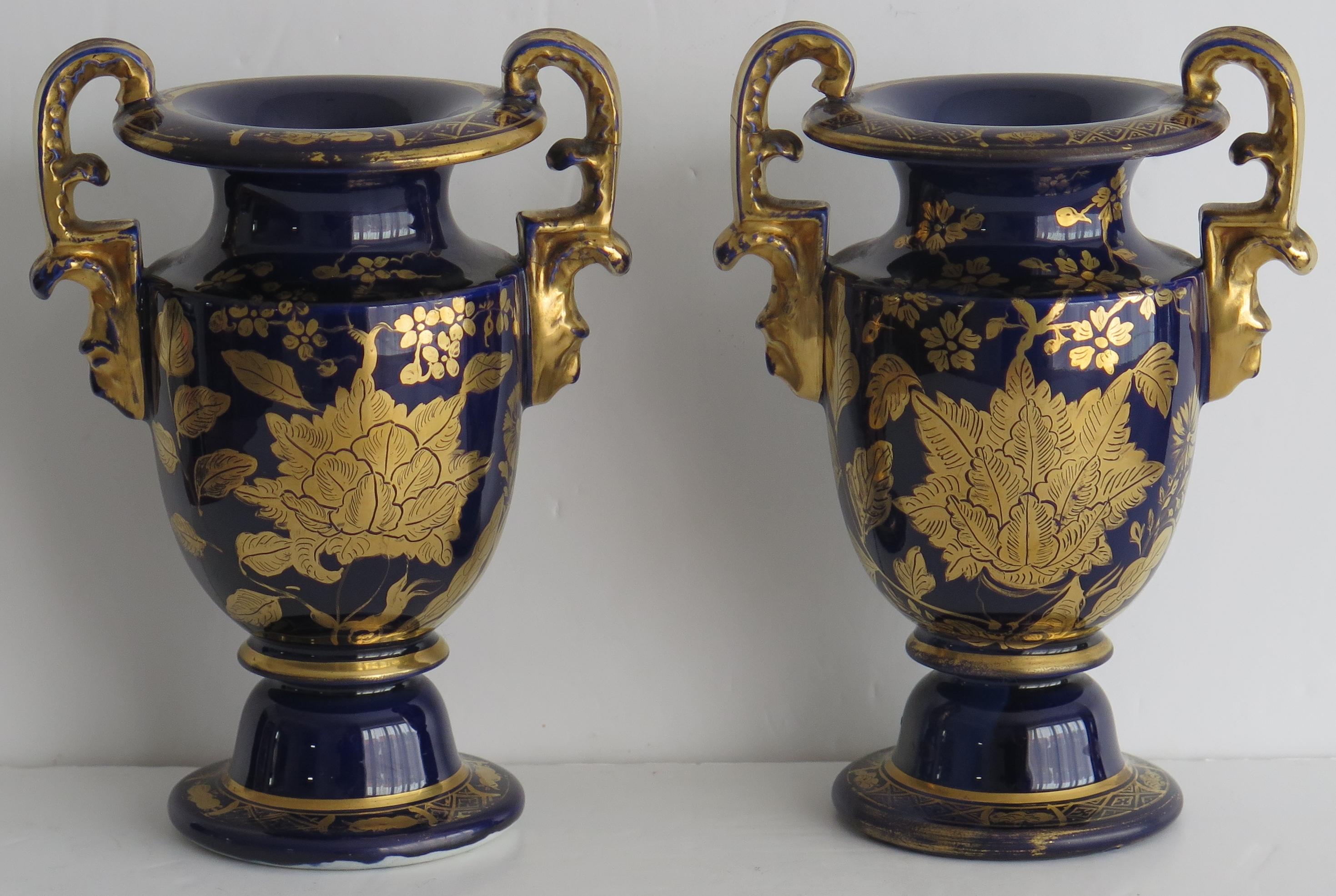 These are a rare pair of ironstone vase with high loop handles, made by the Mason's factory, England in the early 19th century, circa 1815 to 1820.

These footed vases are potted in a rare shape with two elaborately moulded side handles, giving a