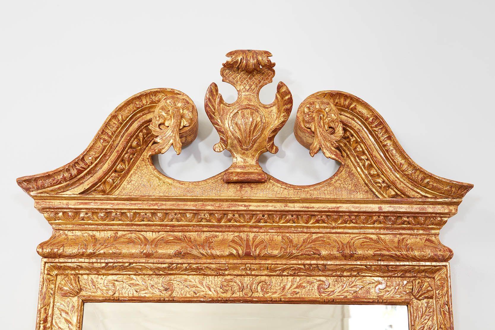 Very fine George II period giltwood mirror, the swan neck pediment with foliate carved scrolls surrounding central shell carved cartouche, the whole with egg and dart molding, the base with shell carving surrounded by scrolls, the background with