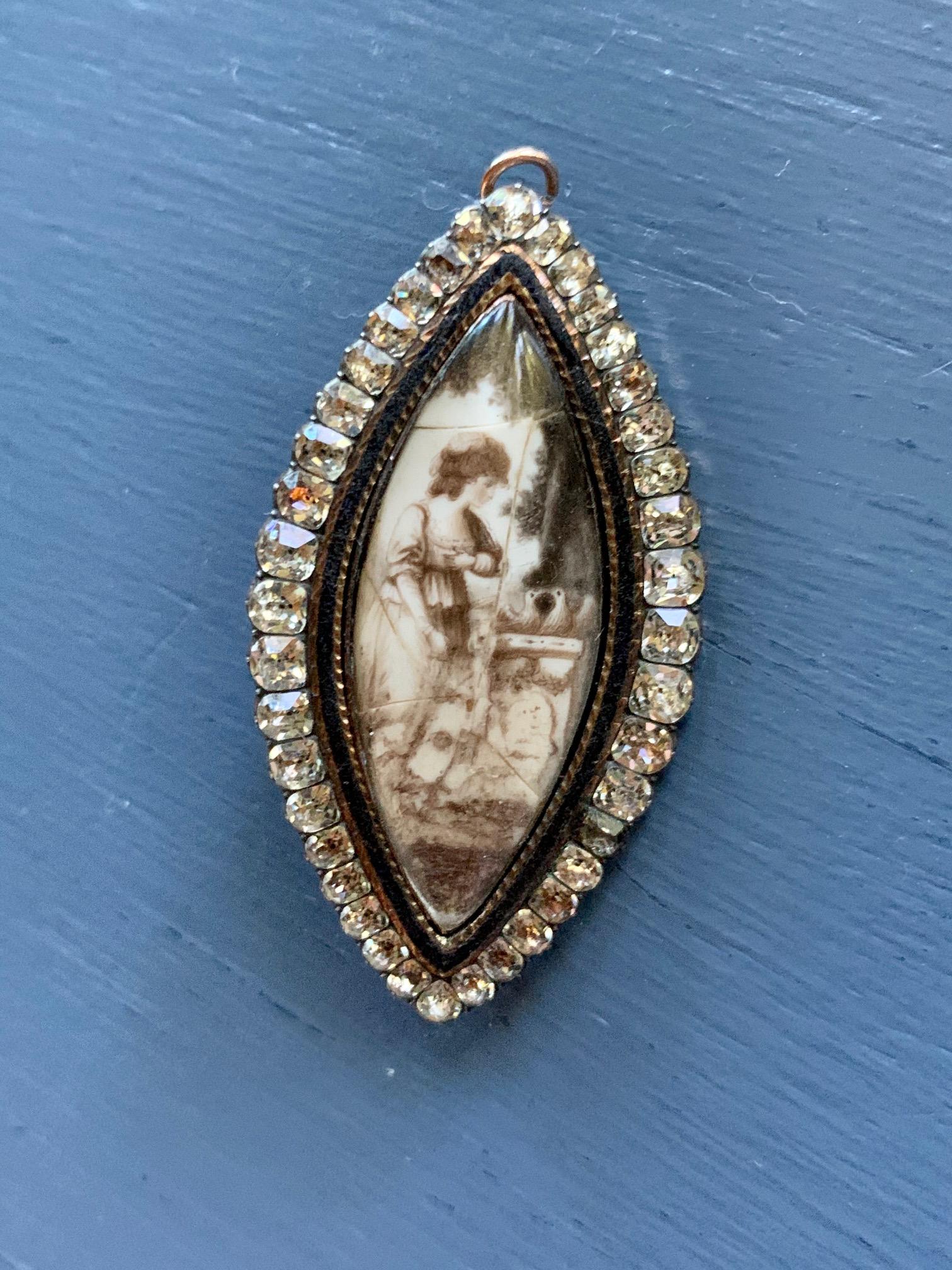 This Georgian Paste and 15 karat Gold (tested) mourning pin and pendant features a sepia portrait of a woman one one side, and a locket on the other side or a photo or lock of hair to memorialize a lost loved one.

This tested 15 karat Gold.

Size: