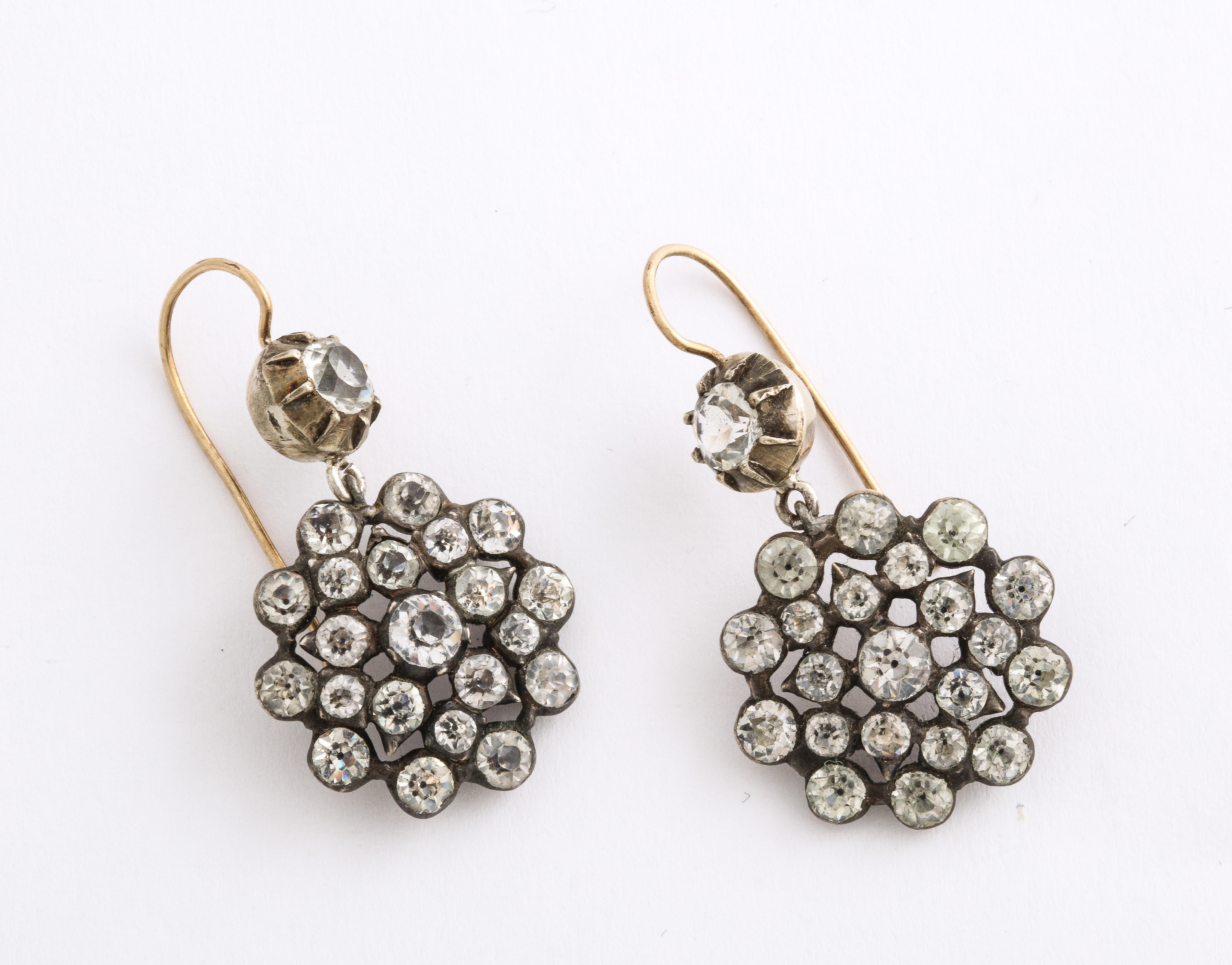Black dot paste are set in a silver snowflake pattern that sway from your ears in these Georgian earrings. The ear wires are gold.
Paste was an art form that dated back to the ancient veneration of glass. It was not an imitation jewel. The paste