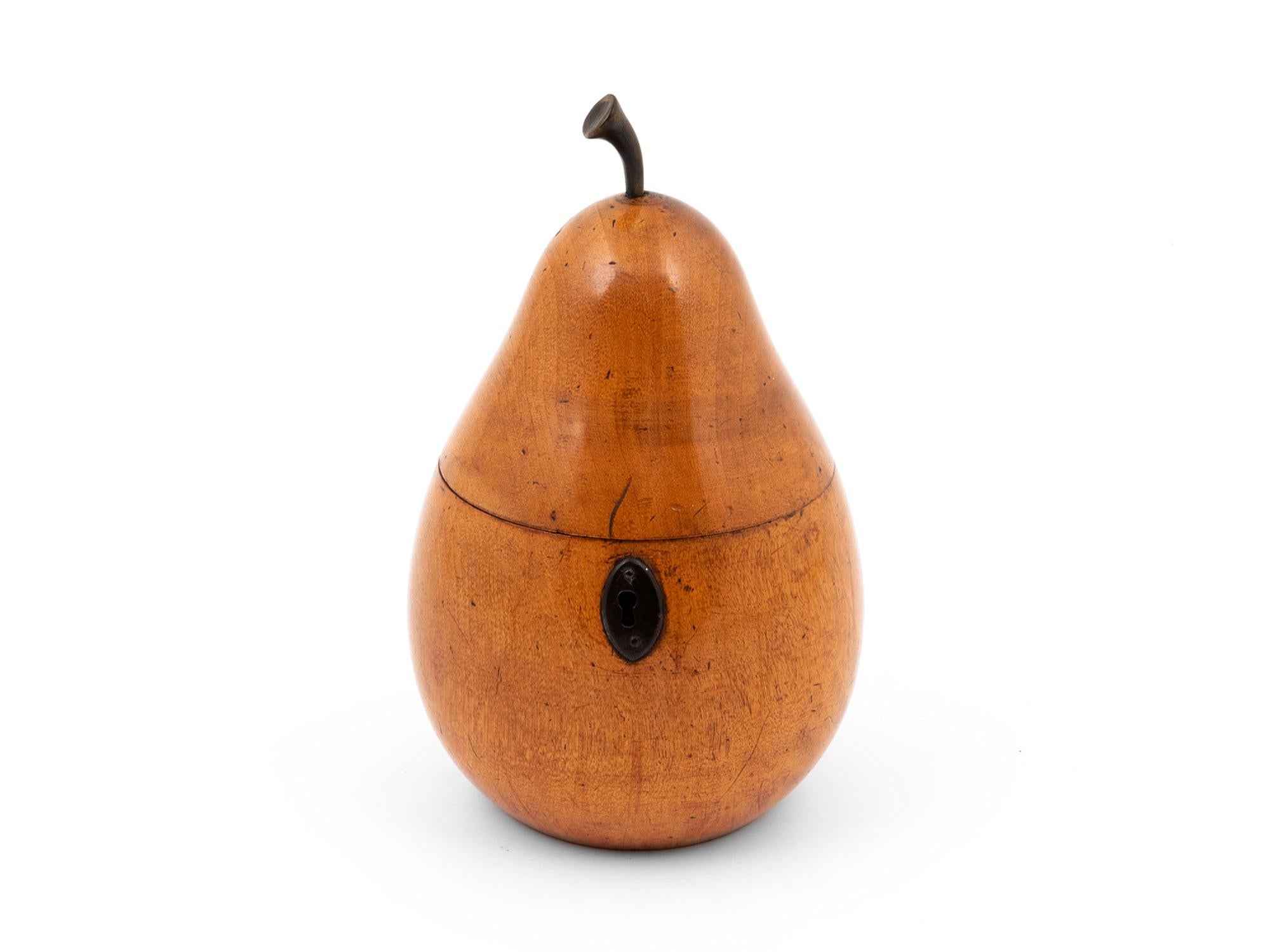 This Unique Antique Pear Tea Caddy holds a beautiful shape and patination, has a steel hinge and escutcheon.

This Pear Tea Caddy is topped with a realistic pear stalk and has a red blush near the base. The Pear's interior has been re-foiled by