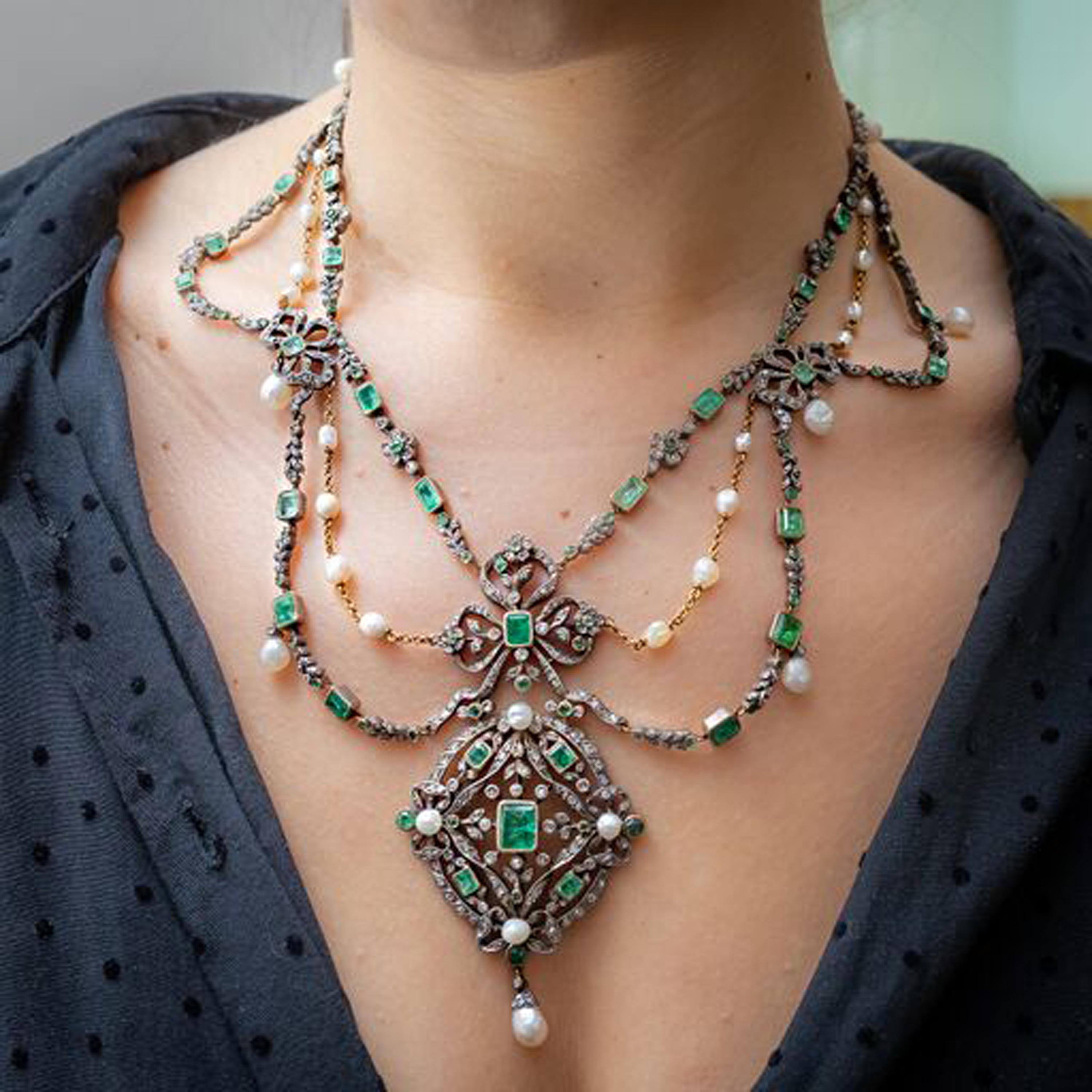 An antique French emerald, pearl and diamond suite, comprising an emerald-cut emerald, natural pearl and rose-cut diamond swag necklace, with an openwork plaque suspending a natural pearl, with four swags, connected by an emerald and diamond bow