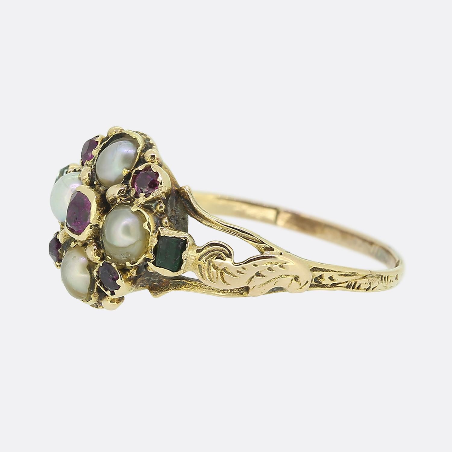 Here we have a charming cluster ring originally dating back to the Georgian period. A quartet of rounded natural pearls dominate the face with an array of almandine garnets neatly nestled in between. A single emerald at either side flanks the main