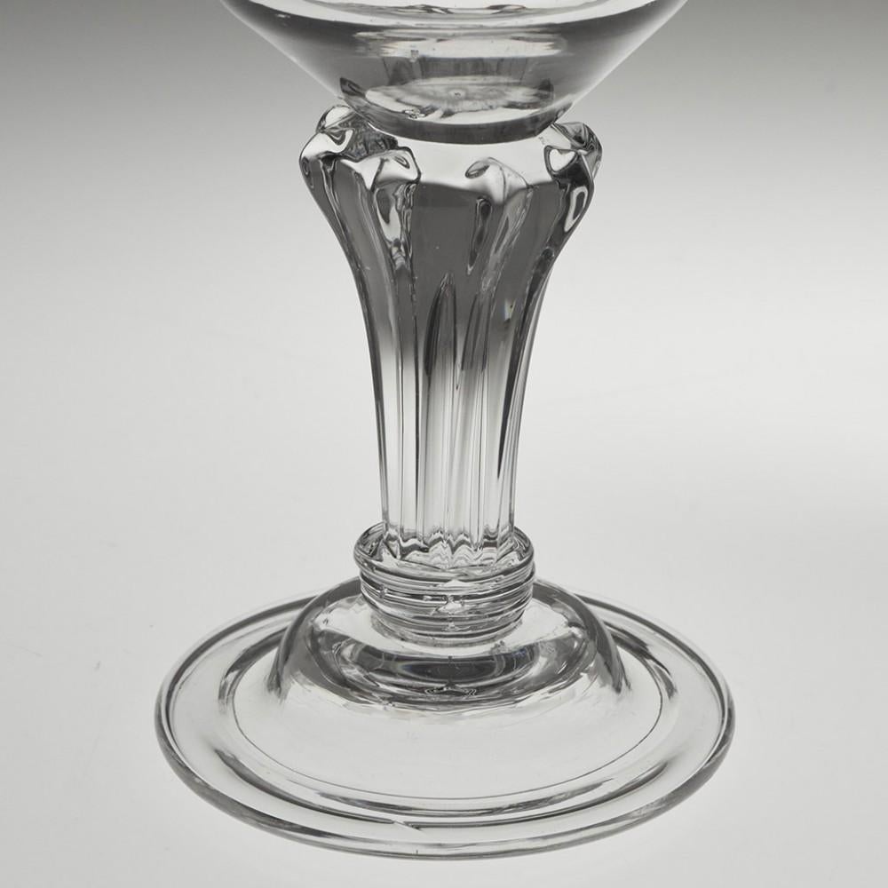 Heading : Pedestal stem Georgian champagne glass
Period : George II - c1750
Origin : England
Colour : Clear
Bowl : Ogee with everted rim
Stem : 8-sided pedestal with diamond shoulders and annulated cushion
Foot : Domed and folded
Pontil :